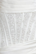 Clara white satin mini dress close - up: intricate lace appliqué with sequins, structured corset bodice detailing
