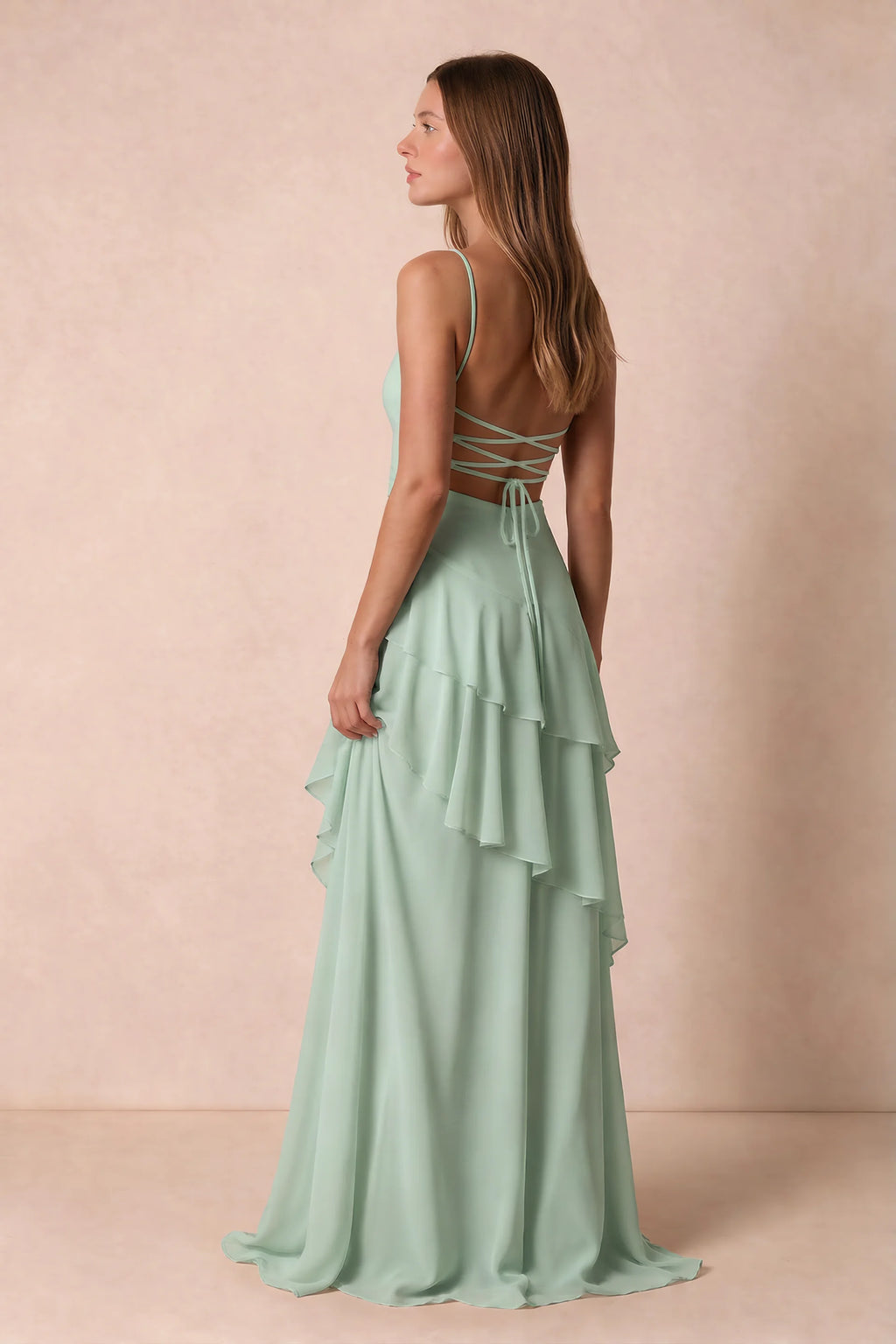Three-quarter rear studio view of Rosalie agave tiered ruffle maxi dress with a long flowing skirt