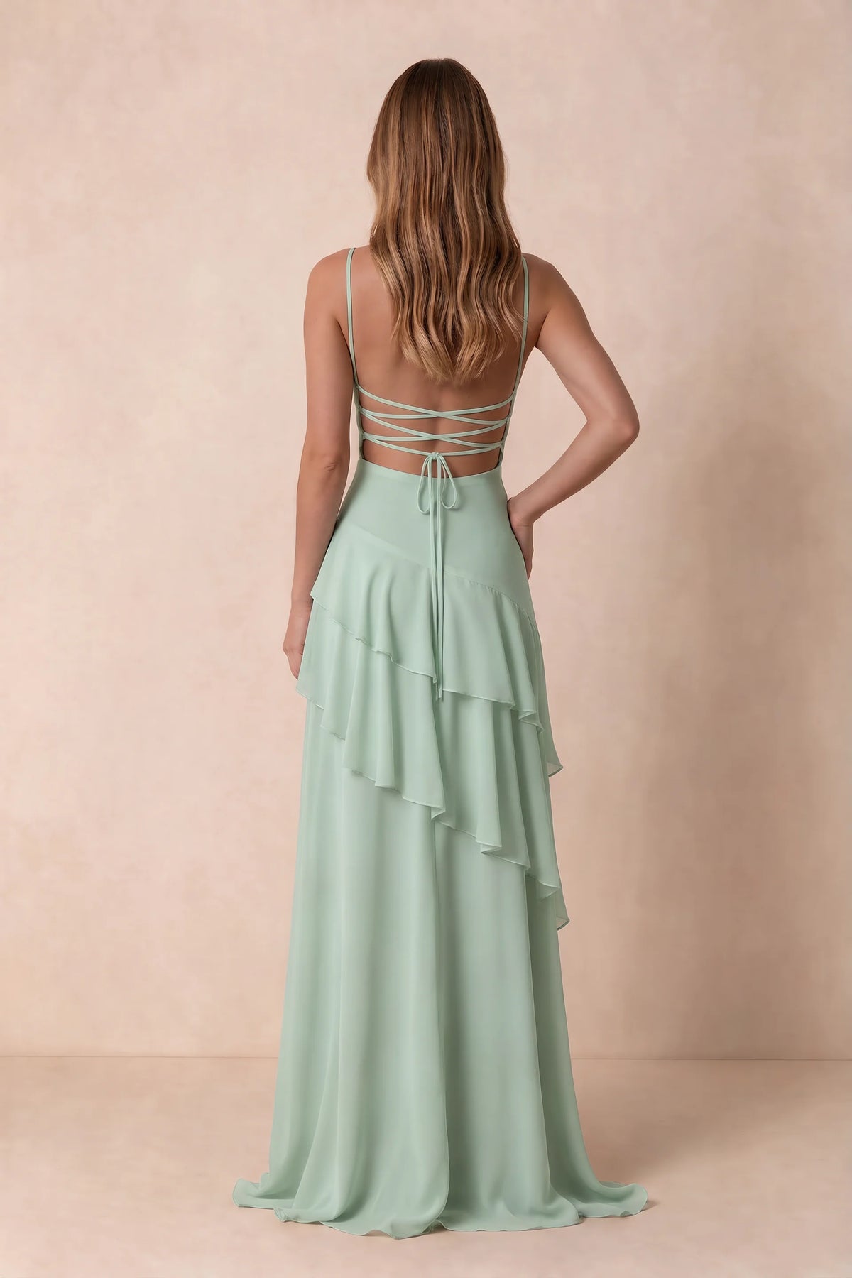 Rear studio view of Rosalie agave tiered ruffle maxi dress with a long flowing skirt