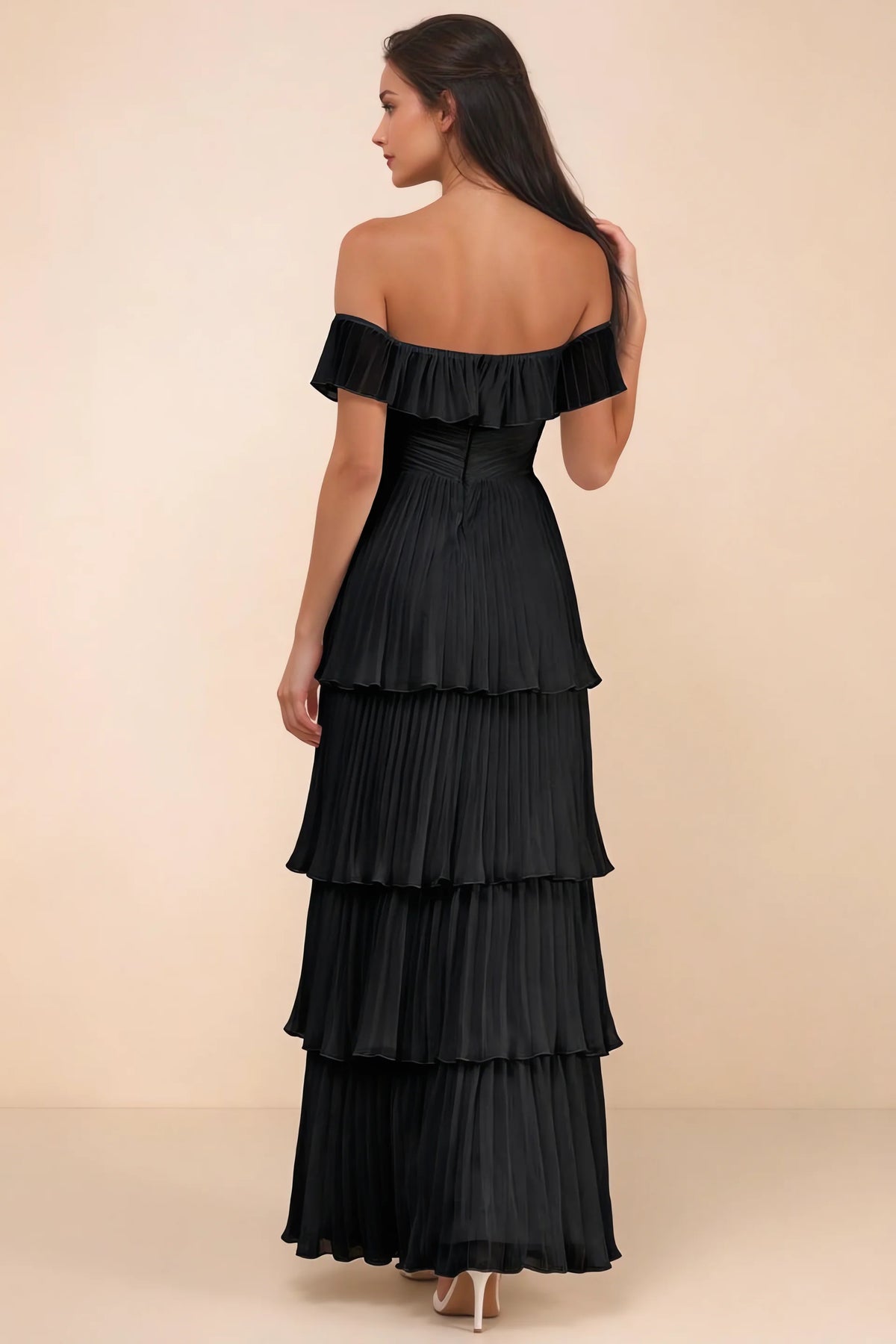 Rear studio view of Seraphina black tiered ruffle maxi dress with a long flowing skirt