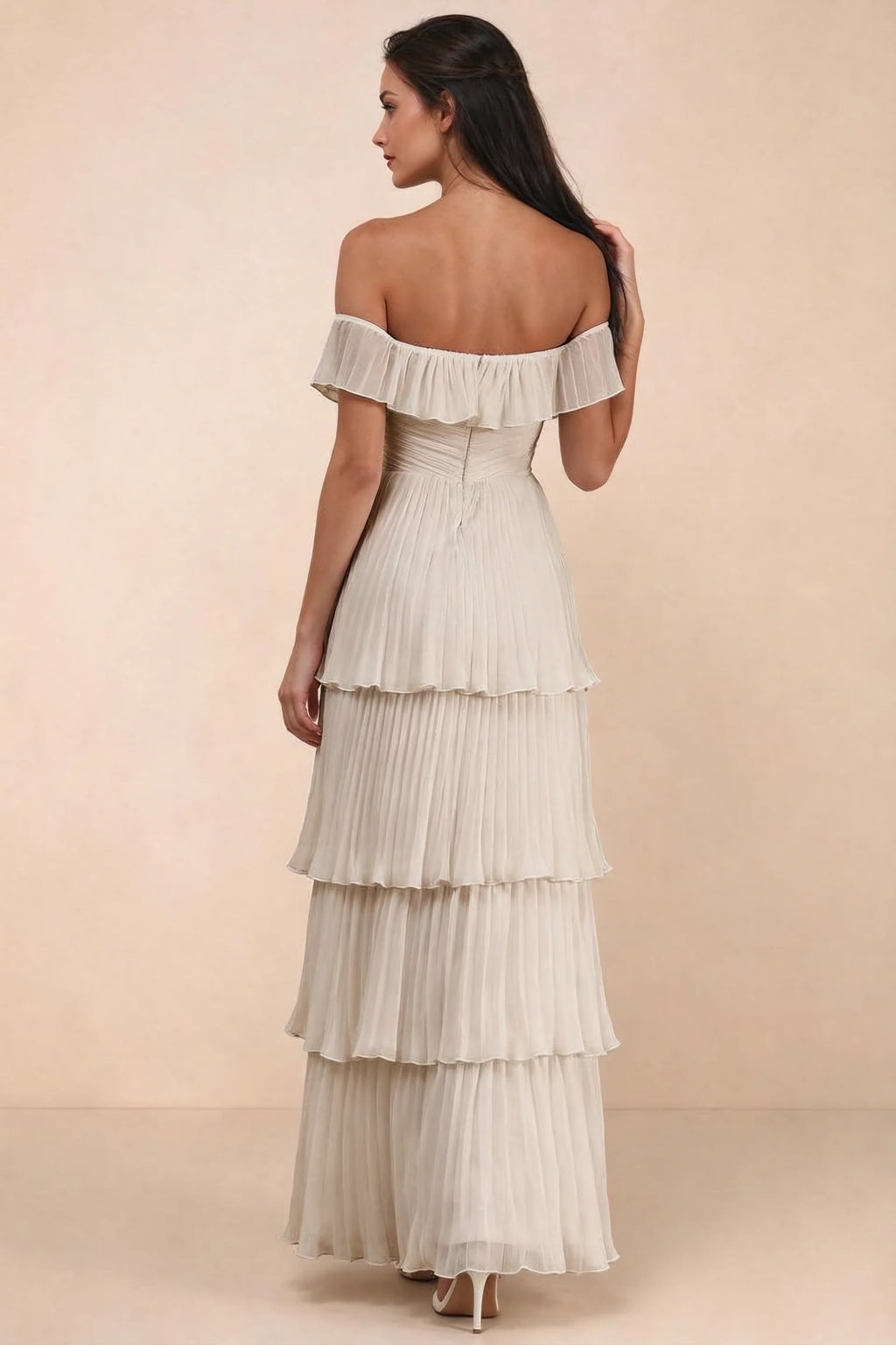 Rear studio view of Seraphina cream tiered ruffle maxi dress with a long flowing skirt