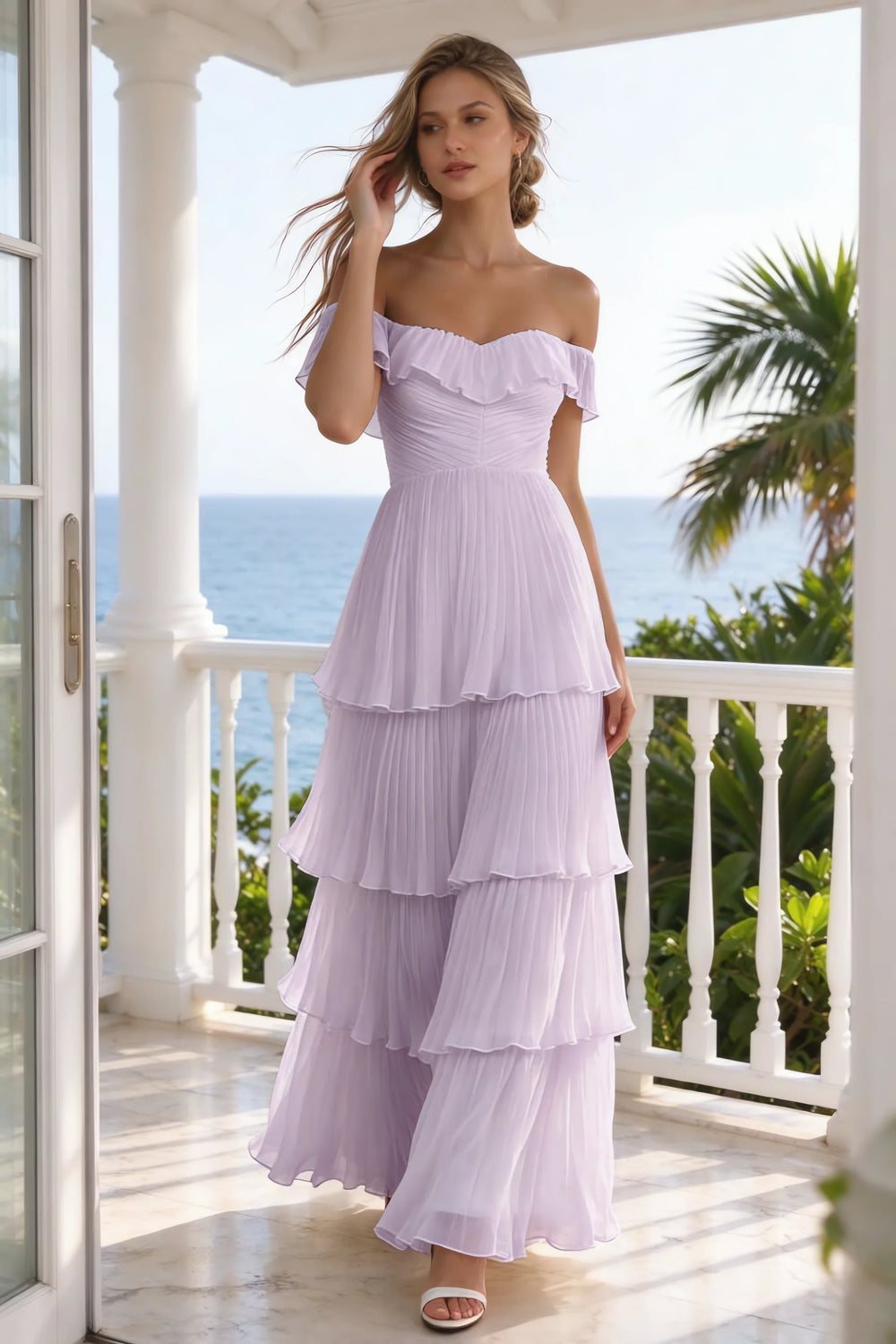 Translation missing: en.Outdoor front view on a seaside terrace of Seraphina lilac tiered ruffle maxi dress with a long flowing skirt content.product_image_secondary