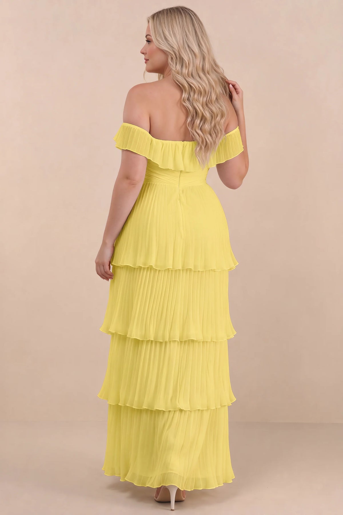 Rear view on a second model of Seraphina pastel yellow tiered ruffle maxi dress with a long flowing skirt
