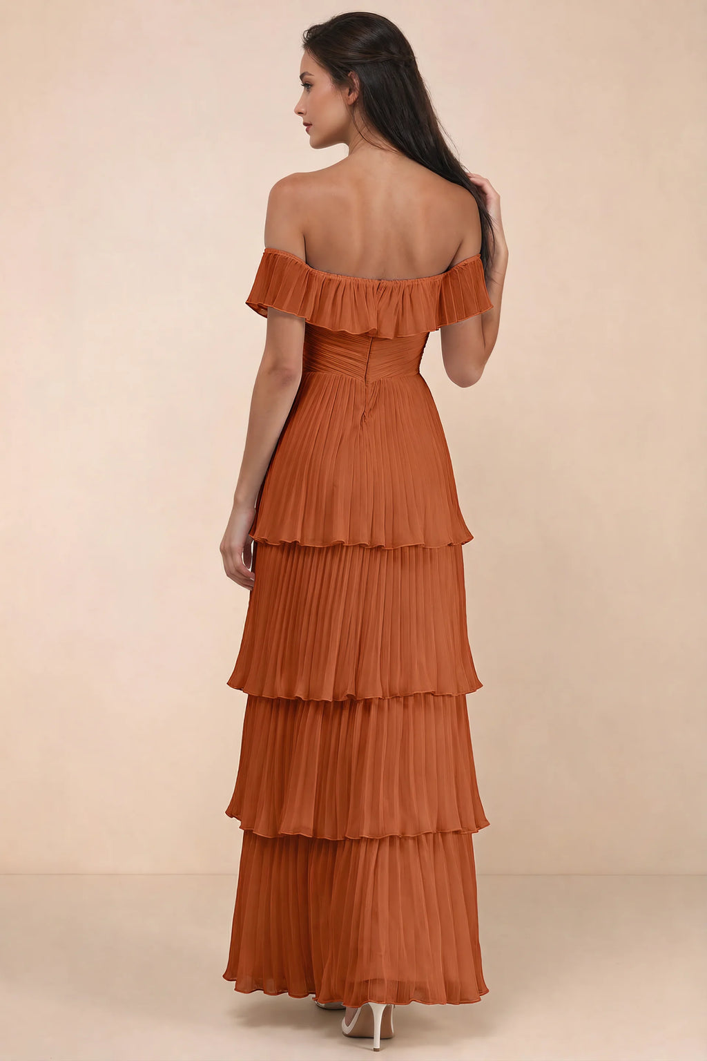 Rear studio view of Seraphina rust tiered ruffle maxi dress with a long flowing skirt