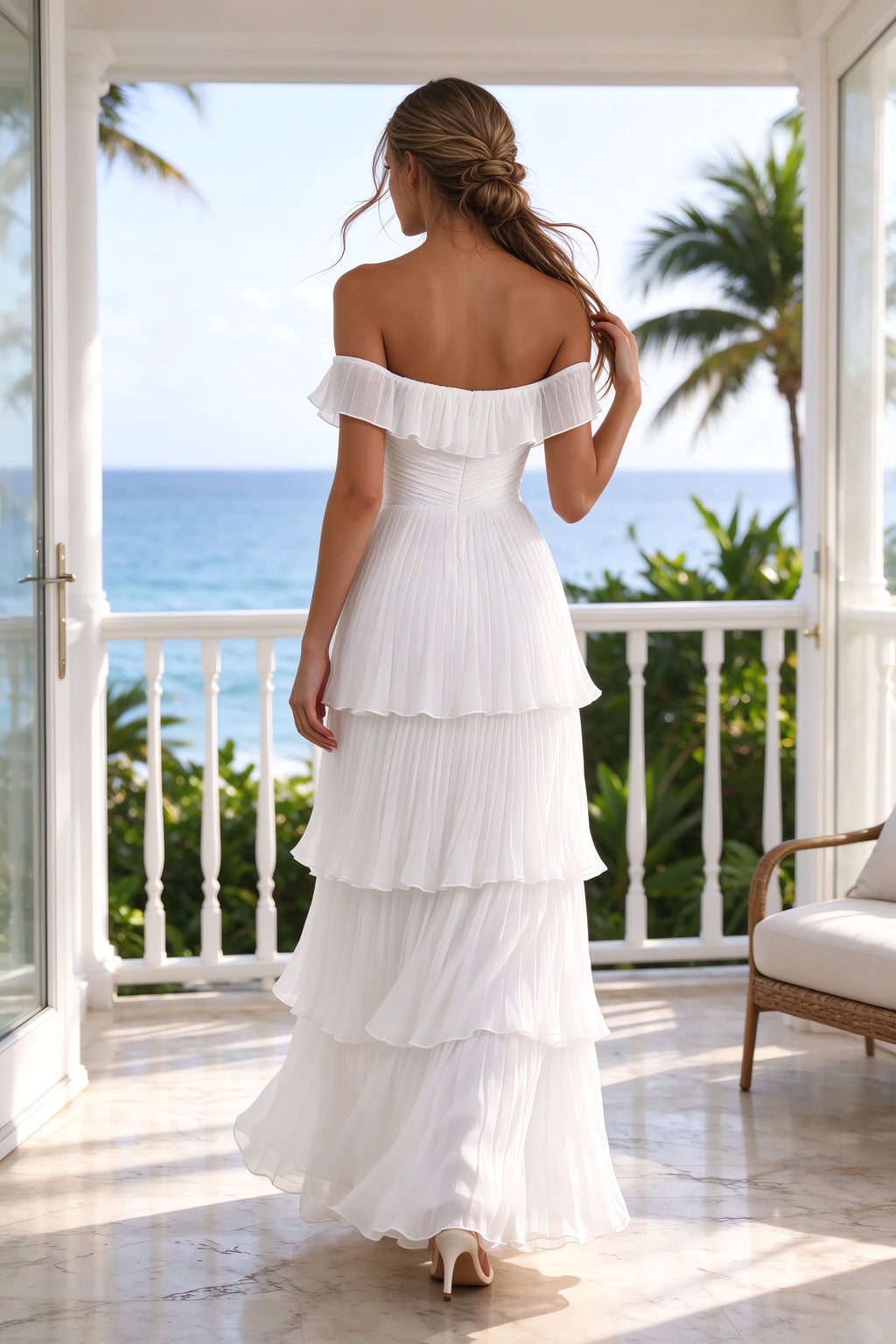 Outdoor rear view on a seaside terrace of Seraphina white tiered ruffle maxi dress with a long flowing skirt