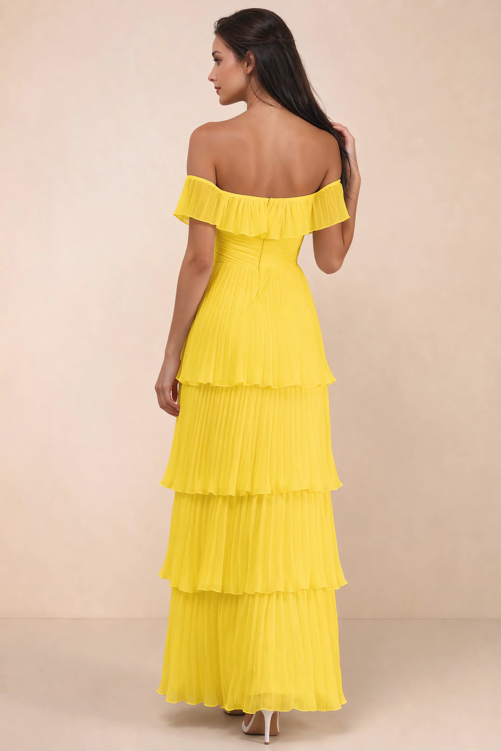 Rear studio view of Seraphina yellow tiered ruffle maxi dress with a long flowing skirt