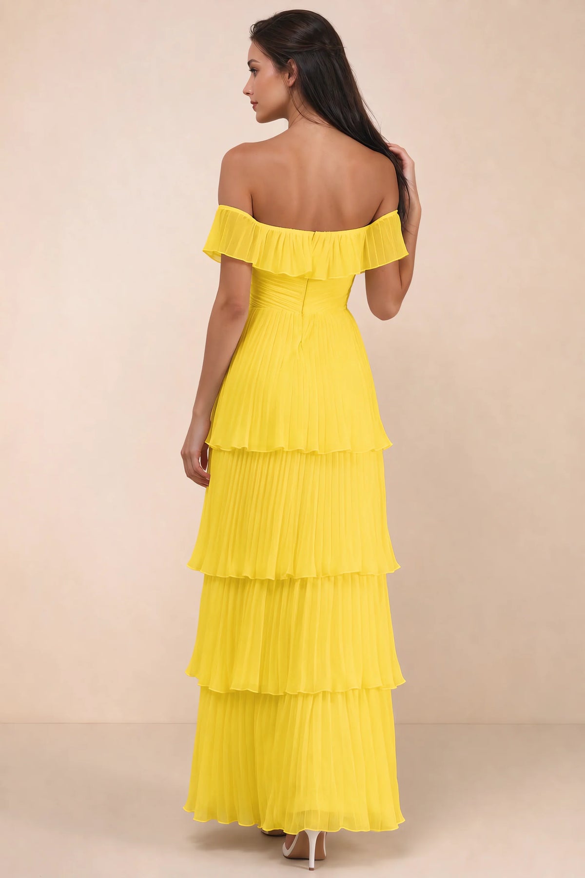 Rear studio view of Seraphina yellow tiered ruffle maxi dress with a long flowing skirt