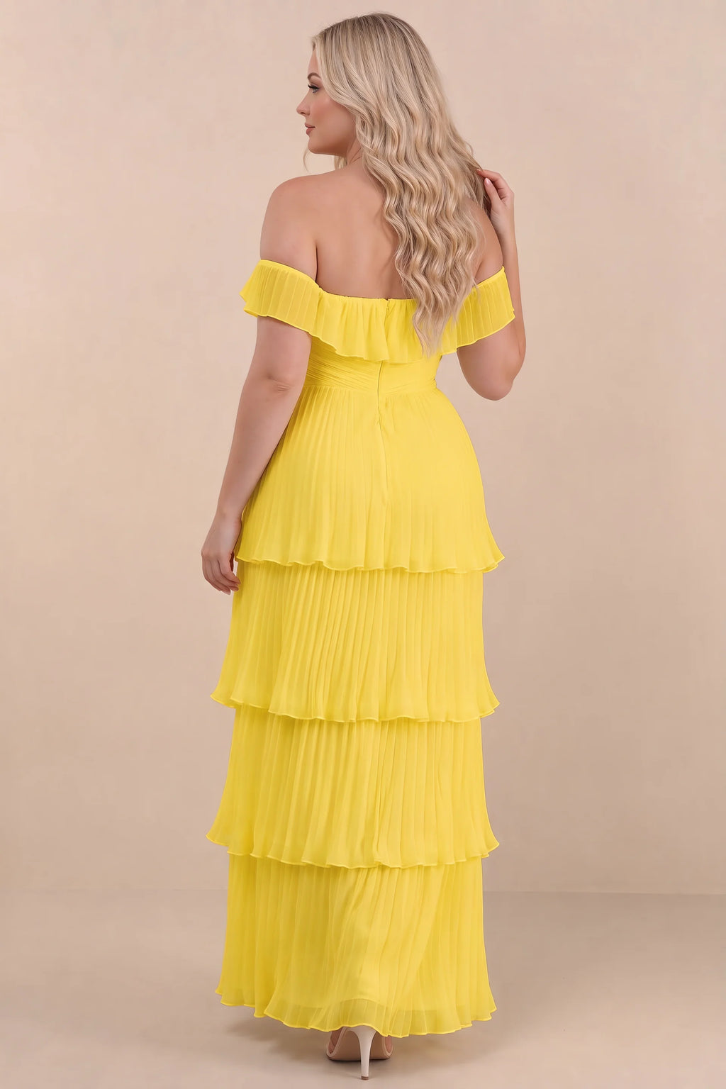Rear view on a second model of Seraphina yellow tiered ruffle maxi dress with a long flowing skirt