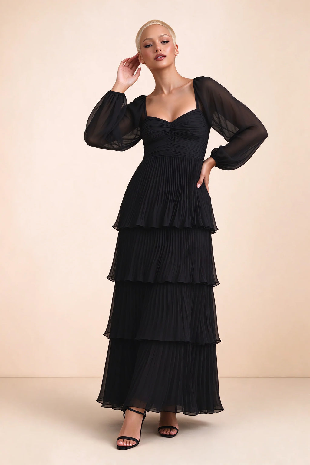 Front studio view of Sienna black tiered pleated maxi dress with a long flowing skirt