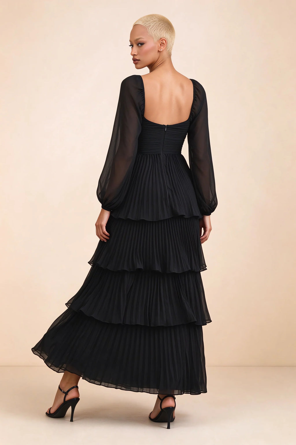 Rear studio view of Sienna black tiered pleated maxi dress with a long flowing skirt