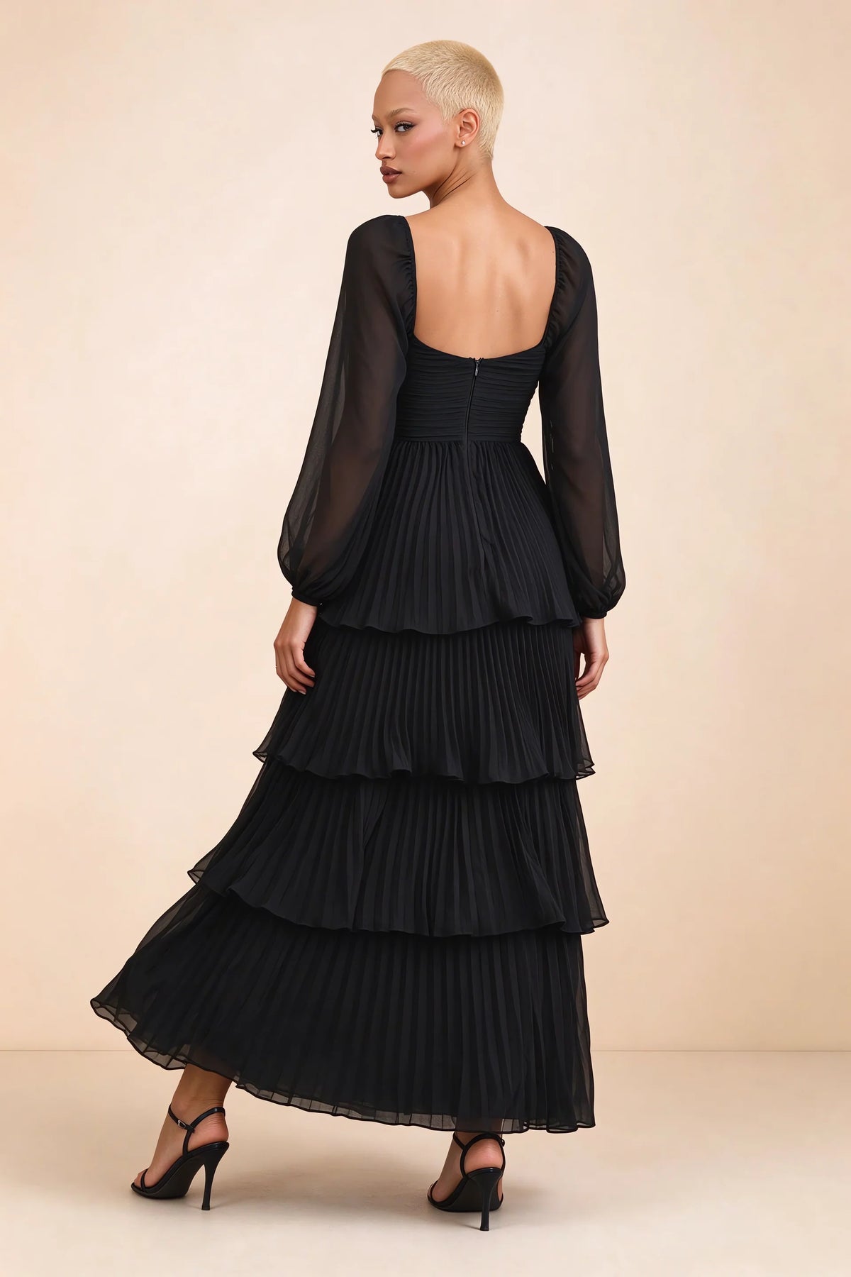 Rear studio view of Sienna black tiered pleated maxi dress with a long flowing skirt