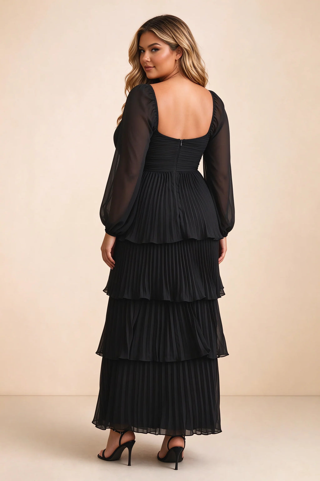 Rear view on a second model of Sienna black tiered pleated maxi dress with a long flowing skirt