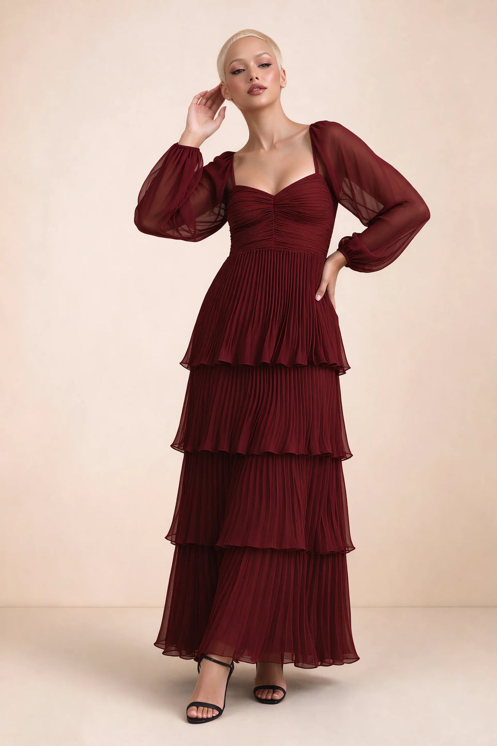 Front studio view of Sienna burgundy tiered pleated maxi dress with a long flowing skirt