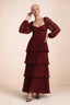 Front studio view of Sienna burgundy tiered pleated maxi dress with a long flowing skirt