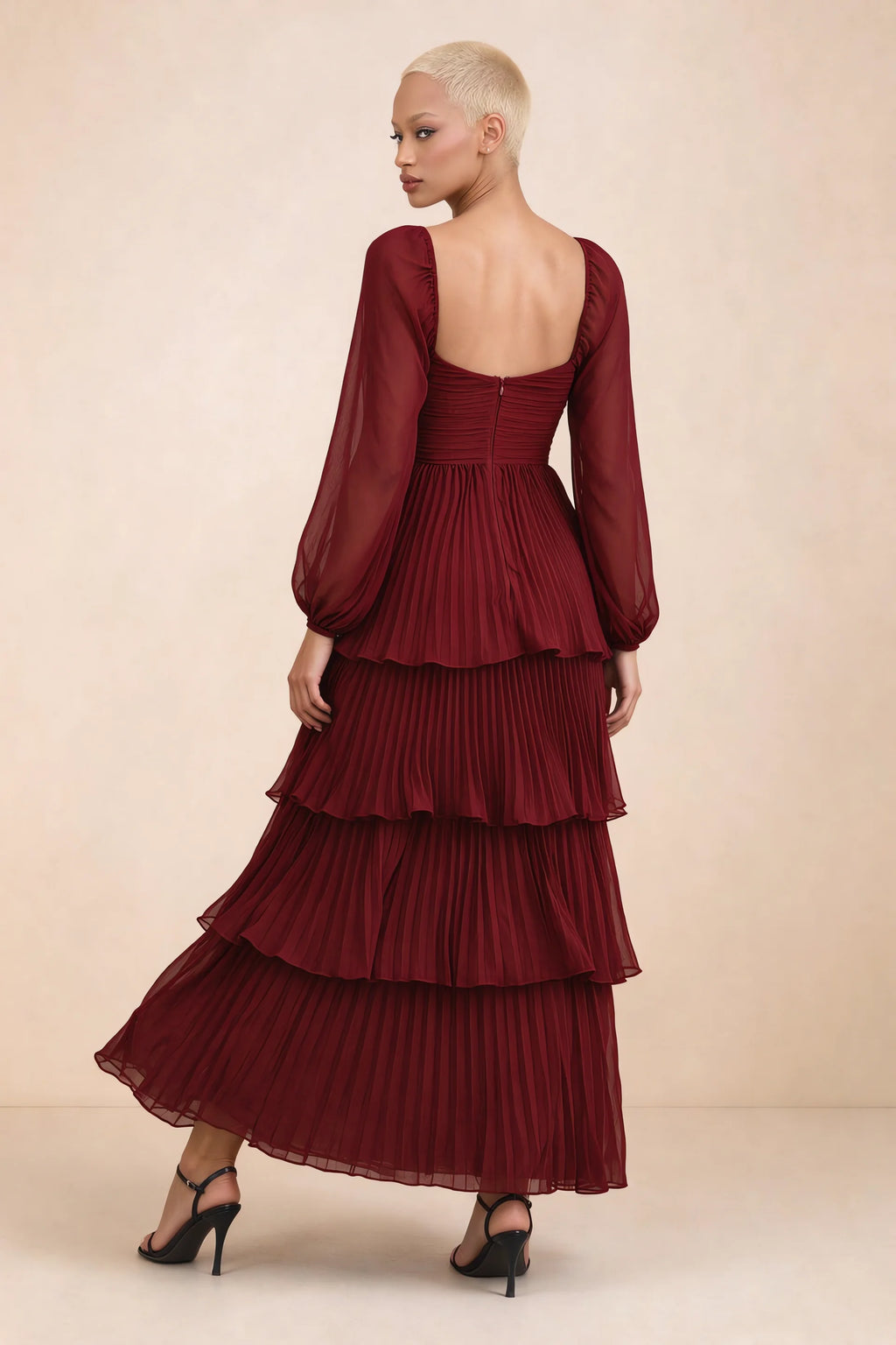 Rear studio view of Sienna burgundy tiered pleated maxi dress with a long flowing skirt