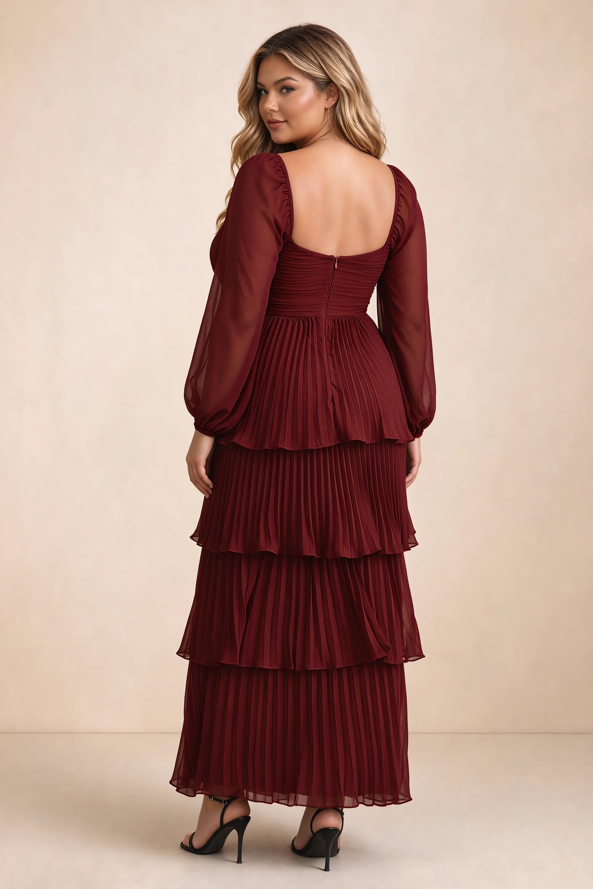 Rear view on a second model of Sienna burgundy tiered pleated maxi dress with a long flowing skirt