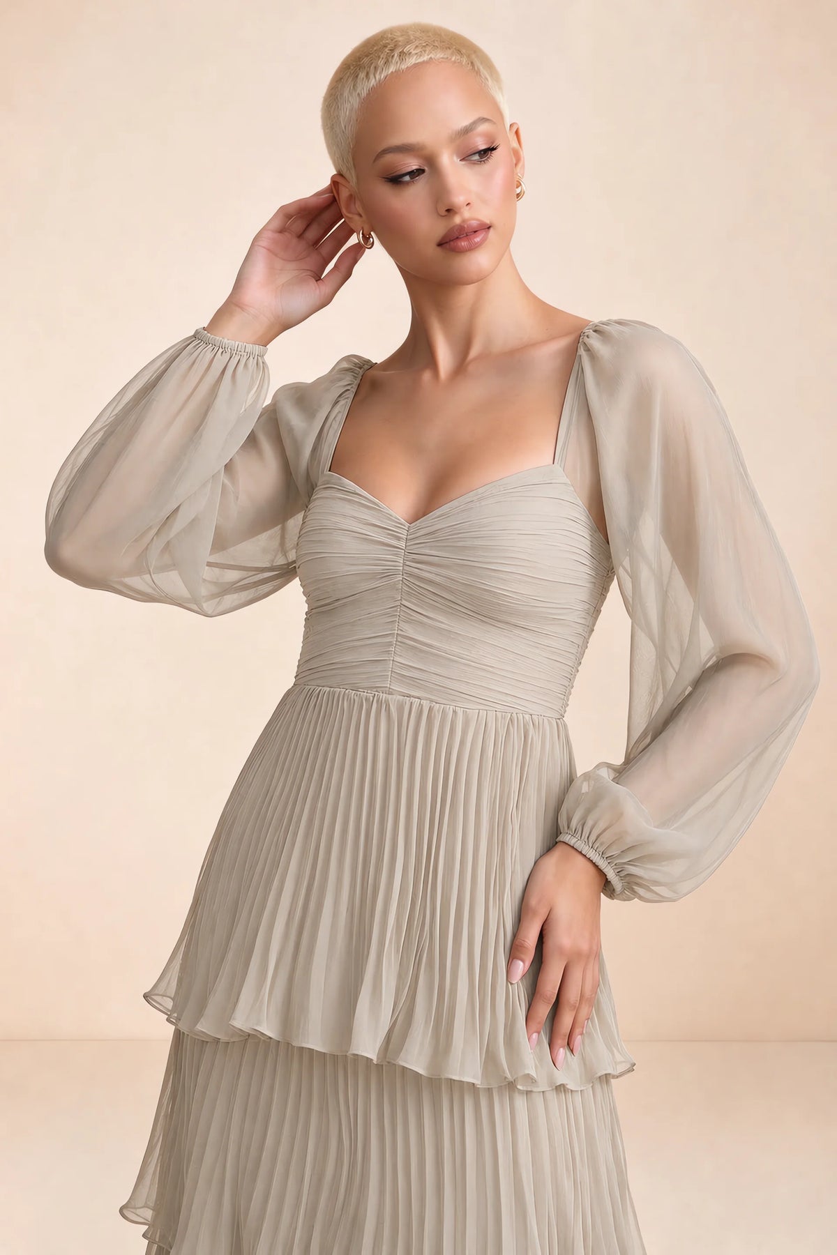 Close-up of sweetheart neckline, sheer sleeves and ruched waist of Sienna cream tiered pleated maxi dress
