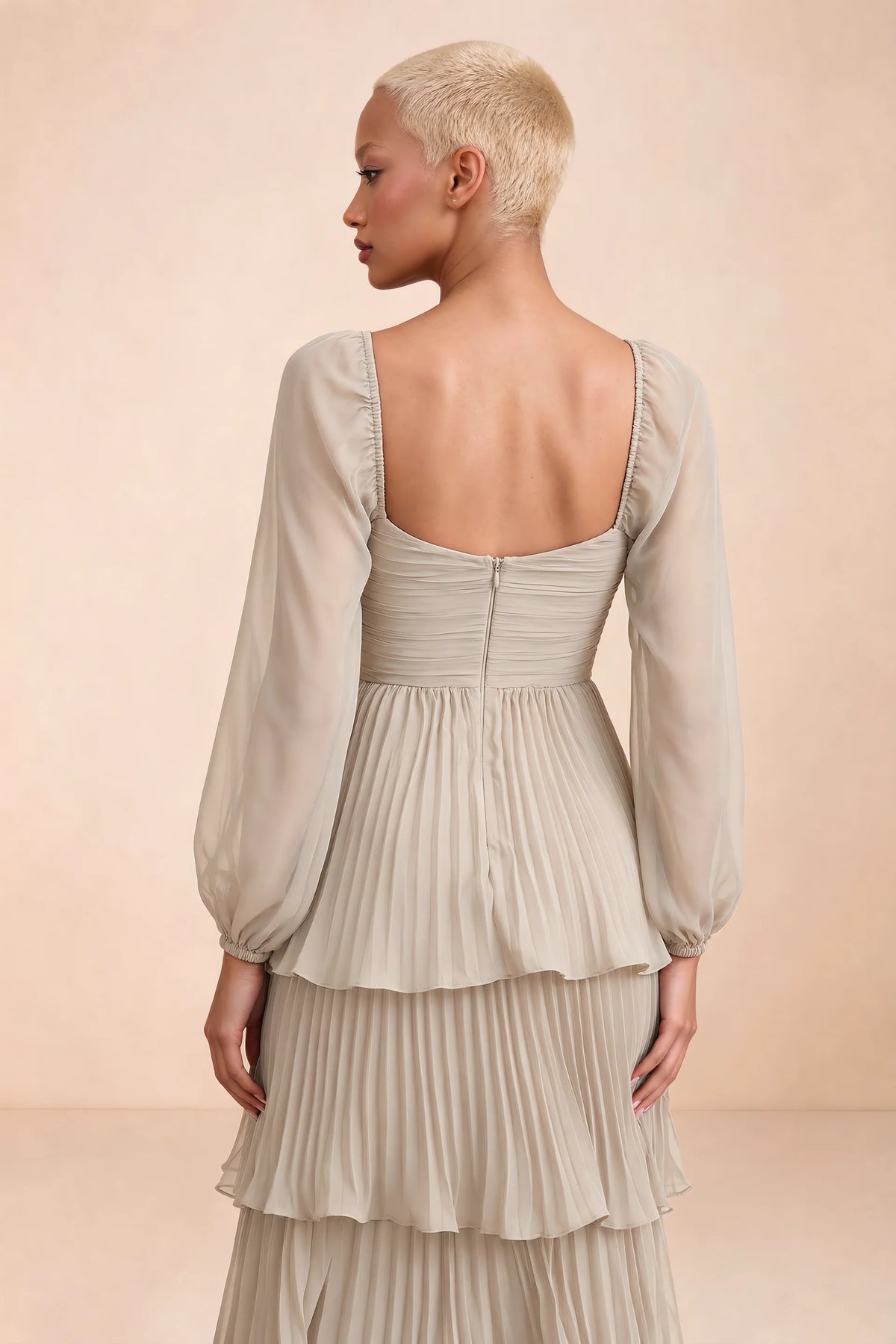 Close-up of low square back, sheer sleeves and centre-back zipper of Sienna cream tiered pleated maxi dress