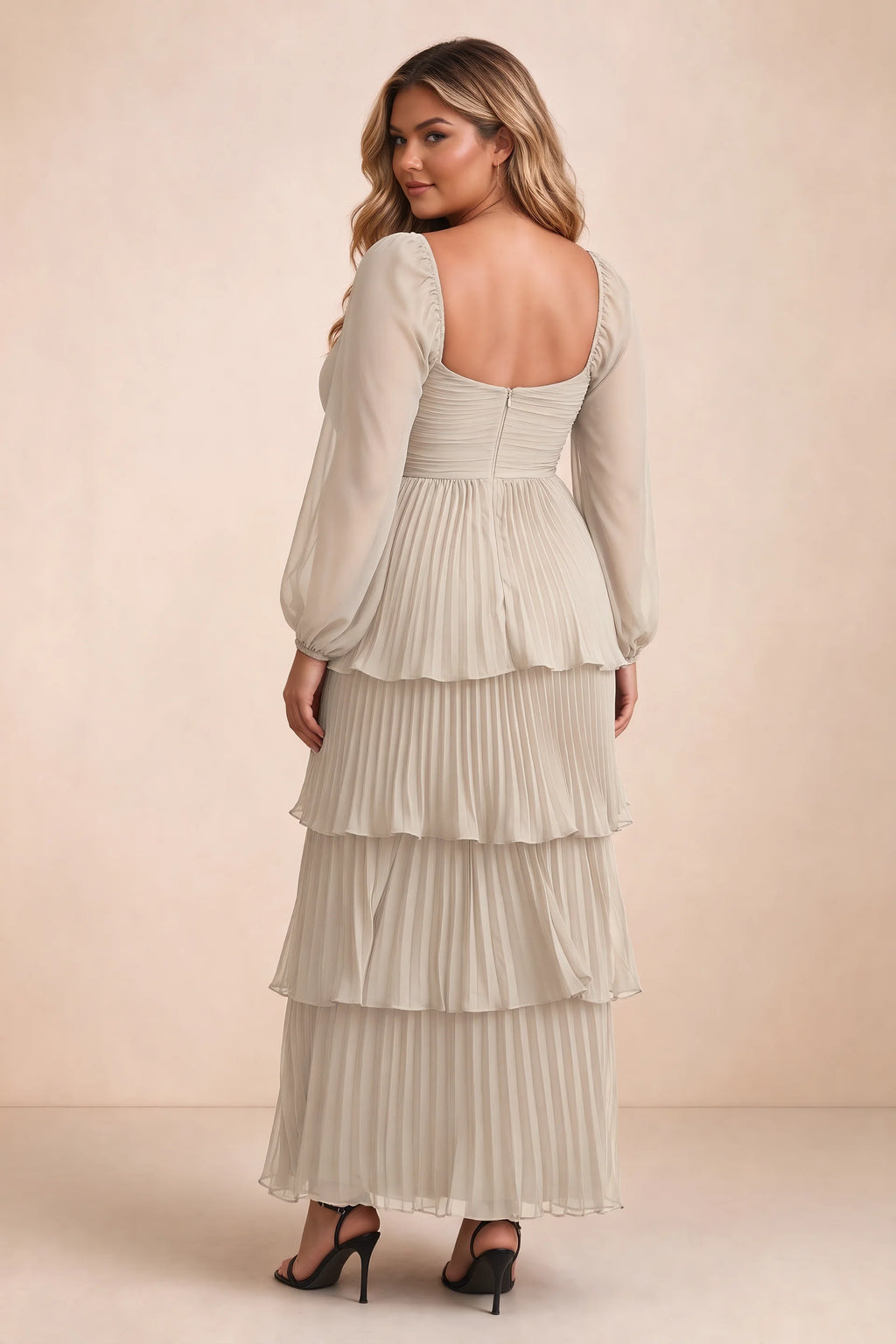 Rear view on a second model of Sienna cream tiered pleated maxi dress with a long flowing skirt
