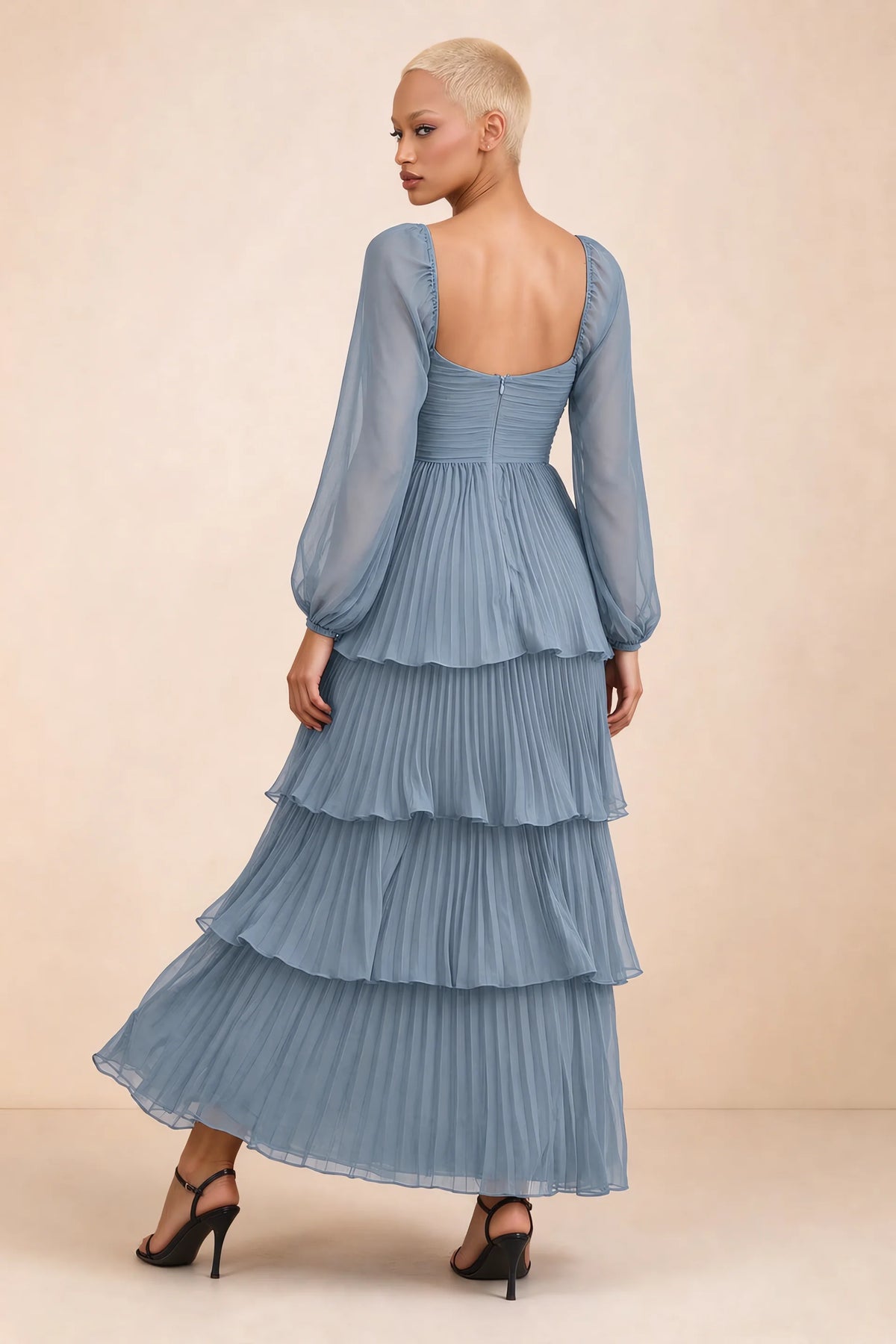 Rear studio view of Sienna dusty blue tiered pleated maxi dress with a long flowing skirt