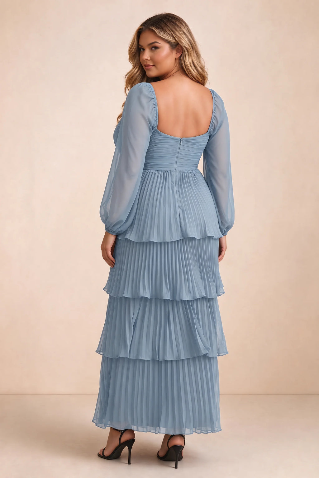 Rear view on a second model of Sienna dusty blue tiered pleated maxi dress with a long flowing skirt