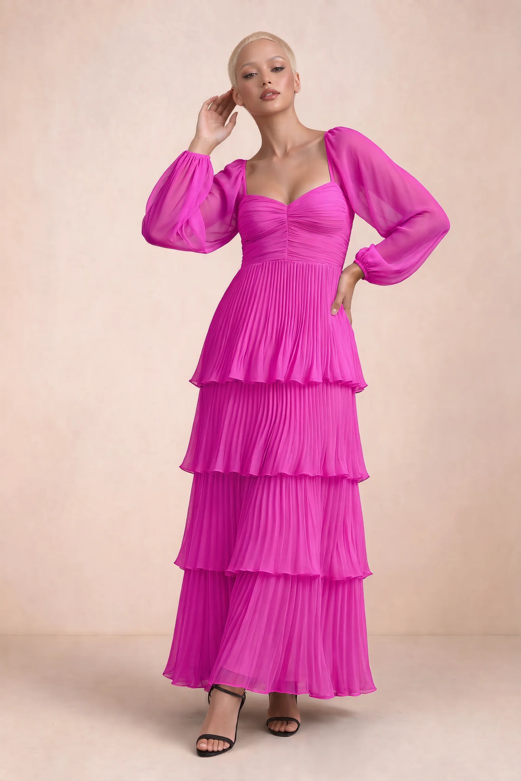 Front studio view of Sienna fuchsia tiered pleated maxi dress with a long flowing skirt