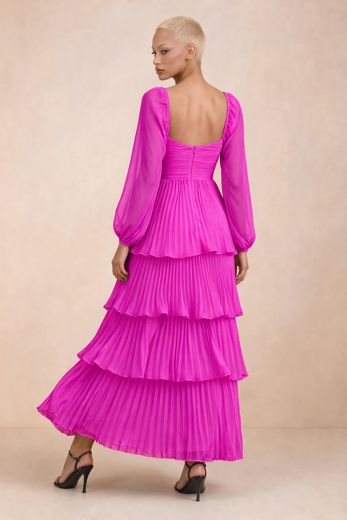 Rear studio view of Sienna fuchsia tiered pleated maxi dress with a long flowing skirt