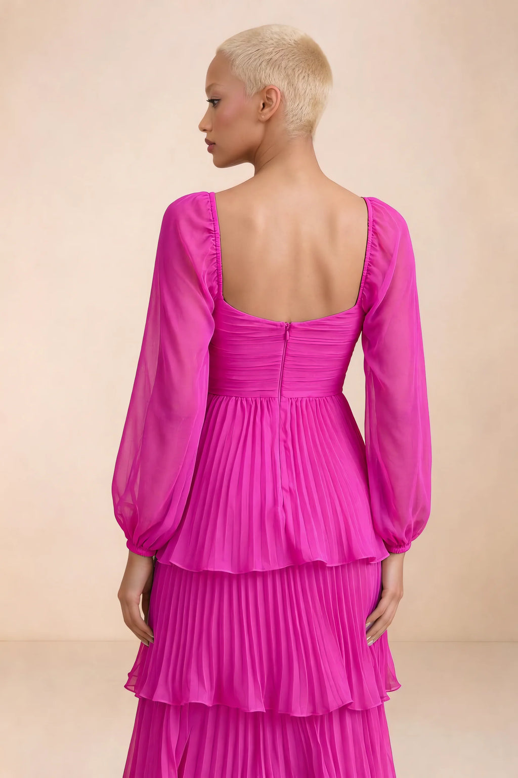 Close-up of low square back, sheer sleeves and centre-back zipper of Sienna fuchsia tiered pleated maxi dress