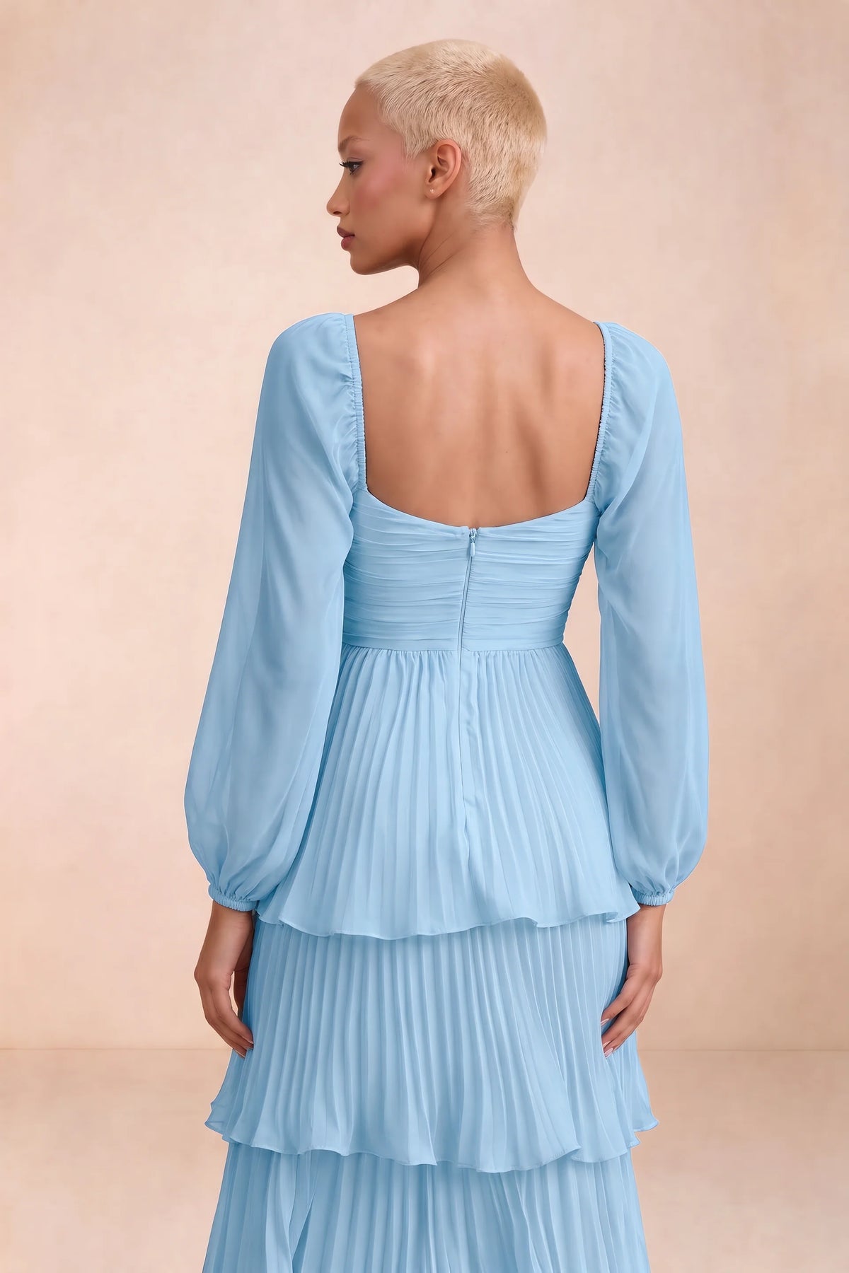 Close-up of low square back, sheer sleeves and centre-back zipper of Sienna haze blue tiered pleated maxi dress