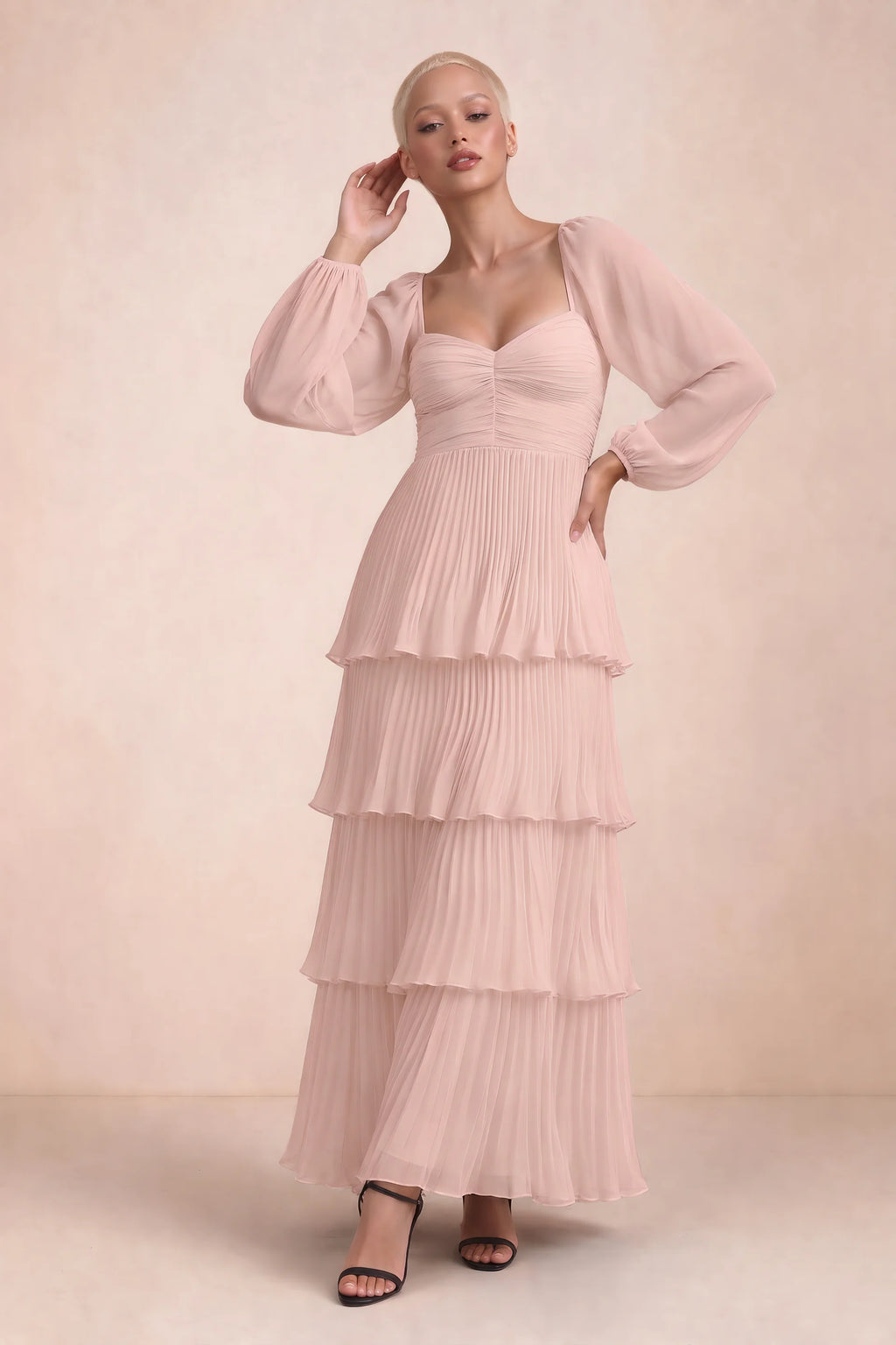 Front studio view of Sienna haze pink tiered pleated maxi dress with a long flowing skirt