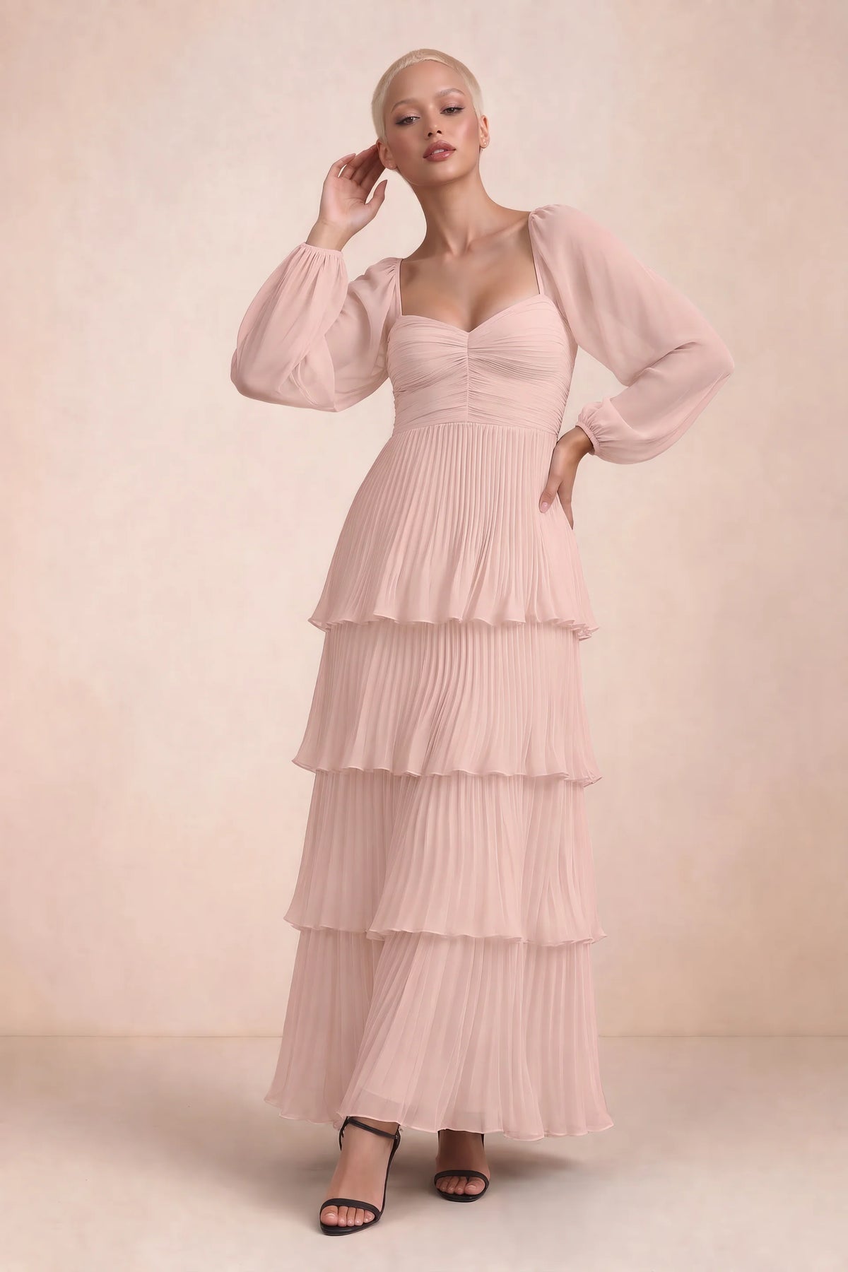 Front studio view of Sienna haze pink tiered pleated maxi dress with a long flowing skirt