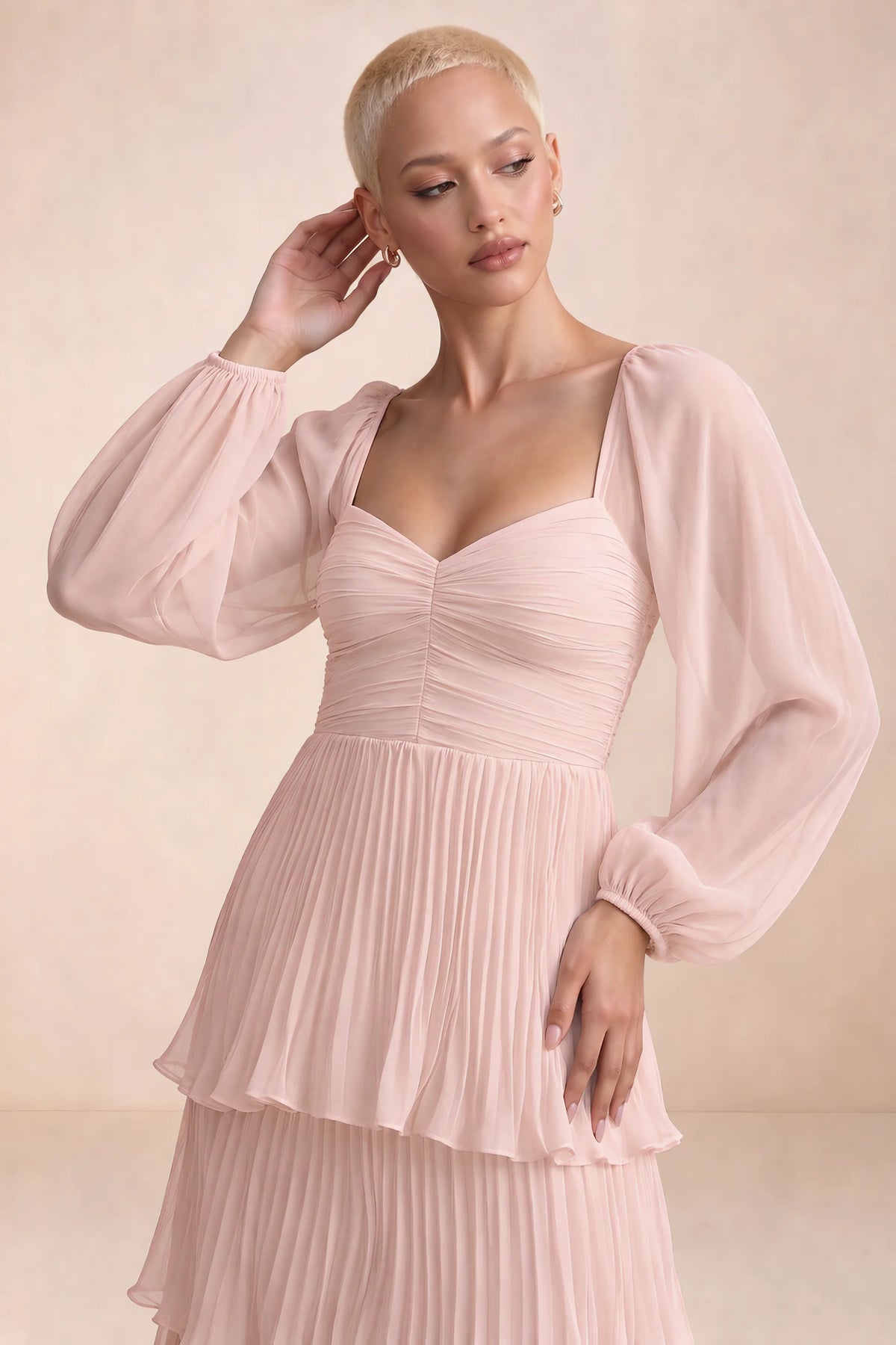 Close-up of sweetheart neckline, sheer sleeves and ruched waist of Sienna haze pink tiered pleated maxi dress