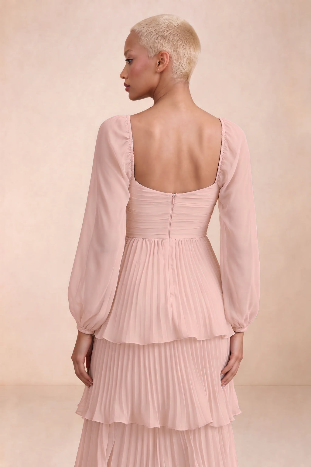 Close-up of low square back, sheer sleeves and centre-back zipper of Sienna haze pink tiered pleated maxi dress