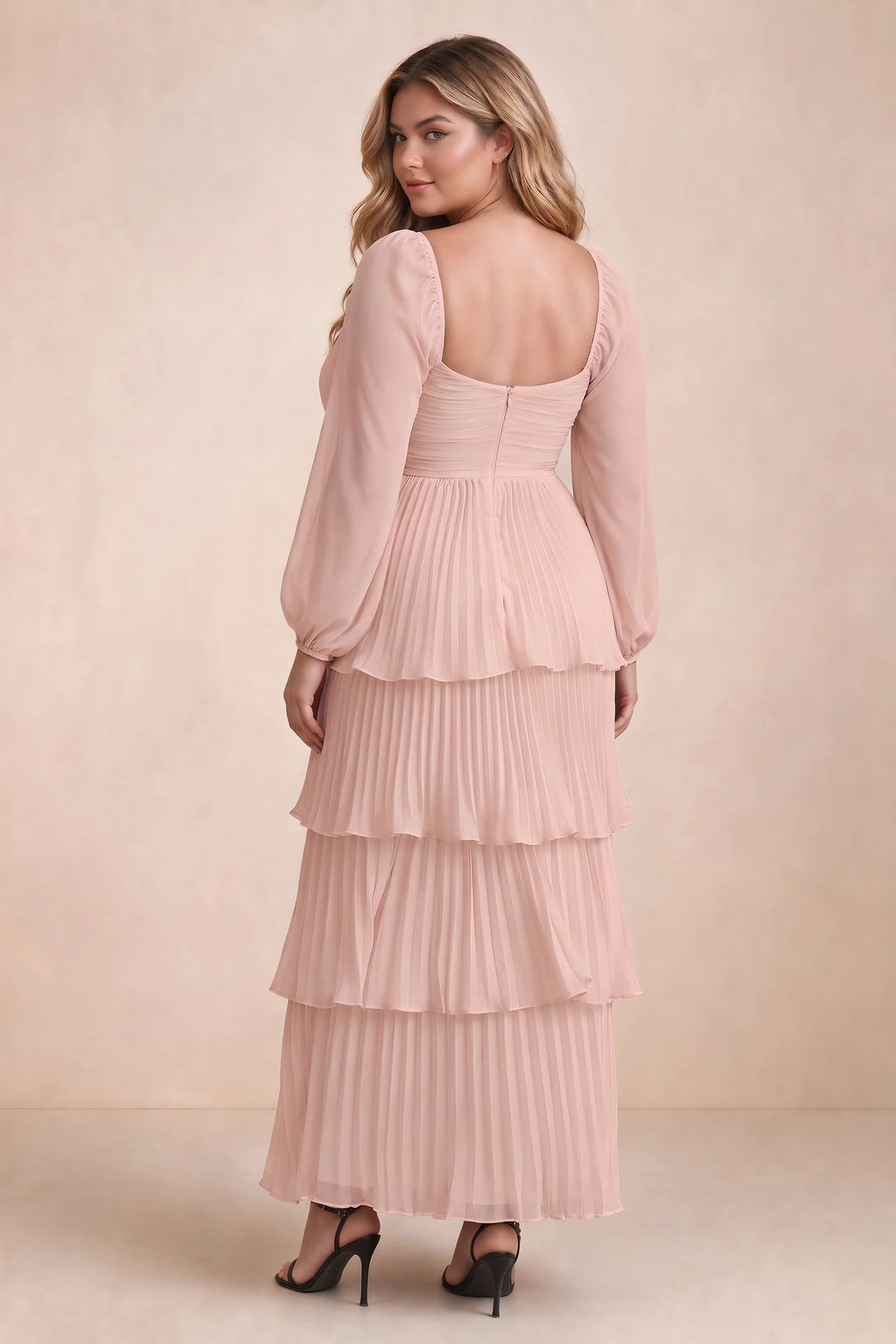 Rear view on a second model of Sienna haze pink tiered pleated maxi dress with a long flowing skirt
