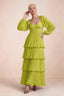 Front studio view of Sienna lemon green tiered pleated maxi dress with a long flowing skirt