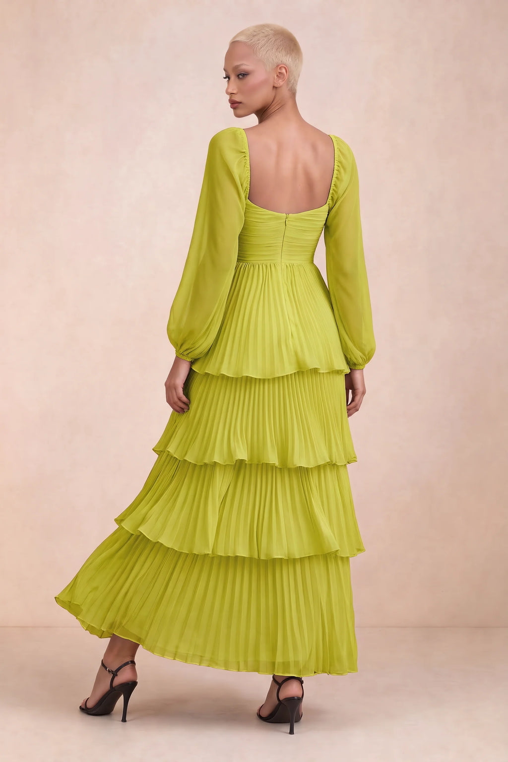 Rear studio view of Sienna lemon green tiered pleated maxi dress with a long flowing skirt
