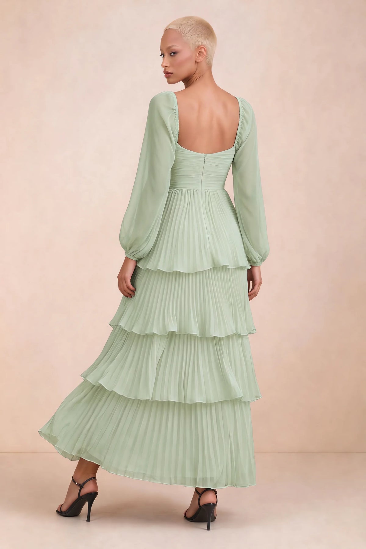 Rear studio view of Sienna light green tiered pleated maxi dress with a long flowing skirt