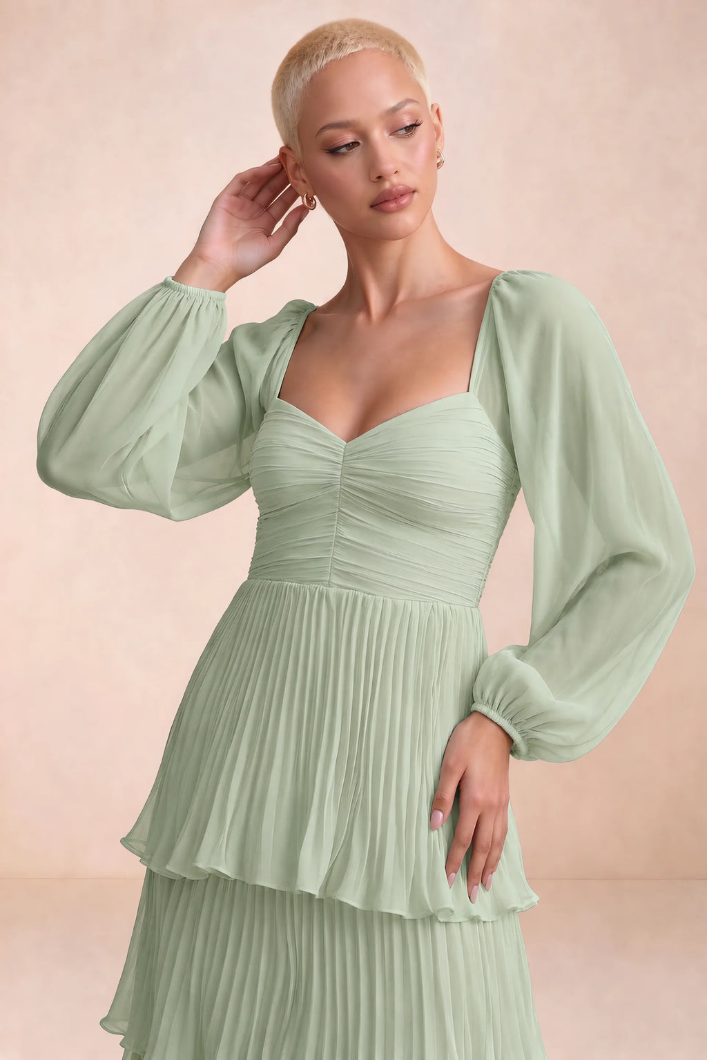 Close-up of sweetheart neckline, sheer sleeves and ruched waist of Sienna light green tiered pleated maxi dress