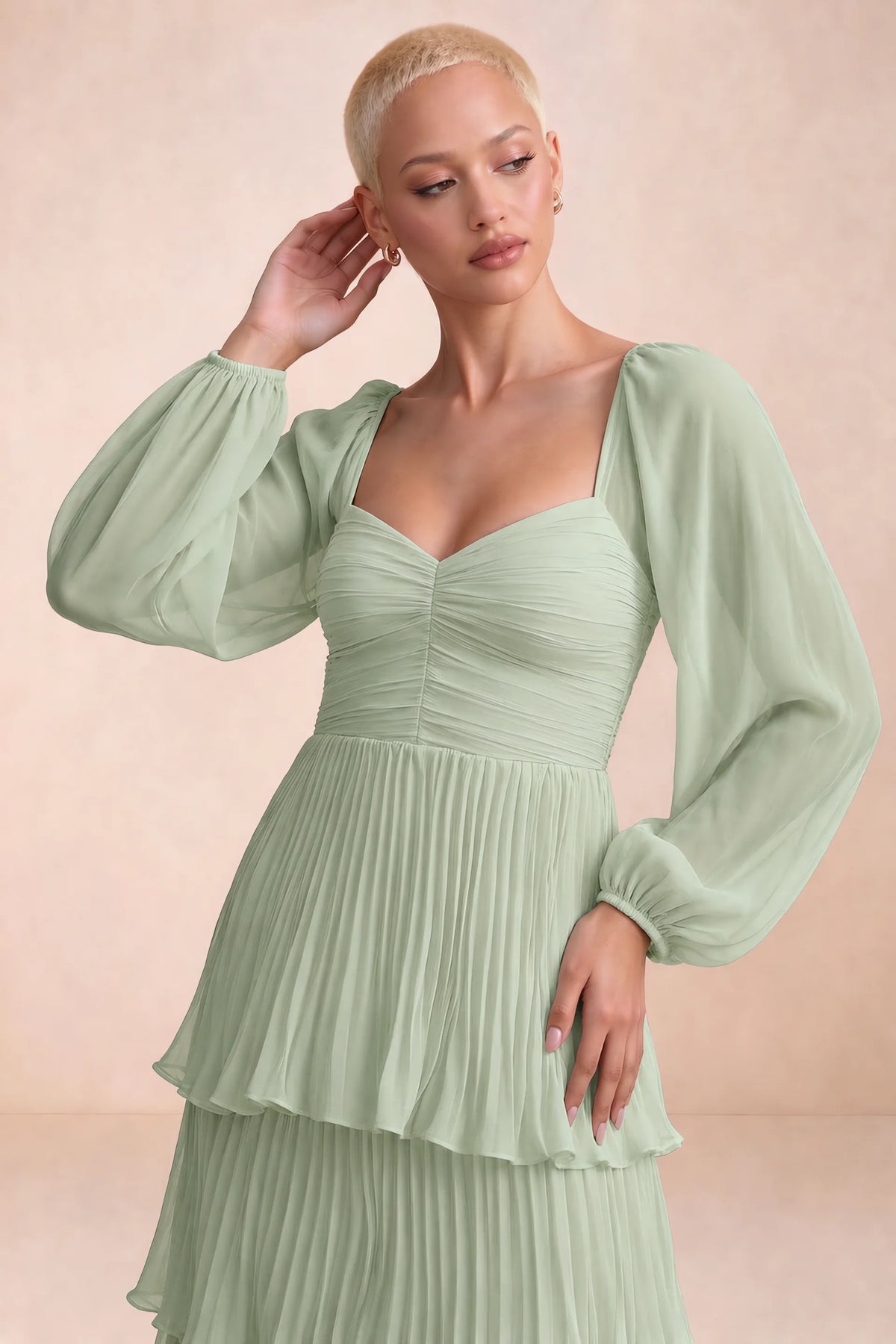 Close-up of sweetheart neckline, sheer sleeves and ruched waist of Sienna light green tiered pleated maxi dress