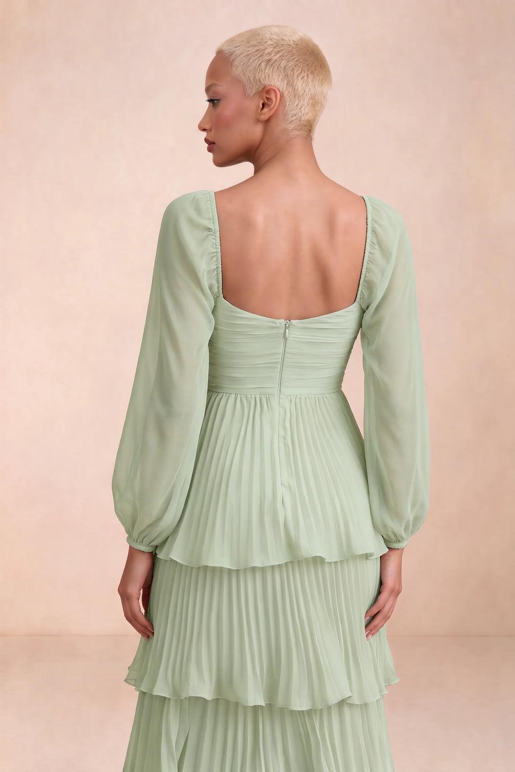 Close-up of low square back, sheer sleeves and centre-back zipper of Sienna light green tiered pleated maxi dress