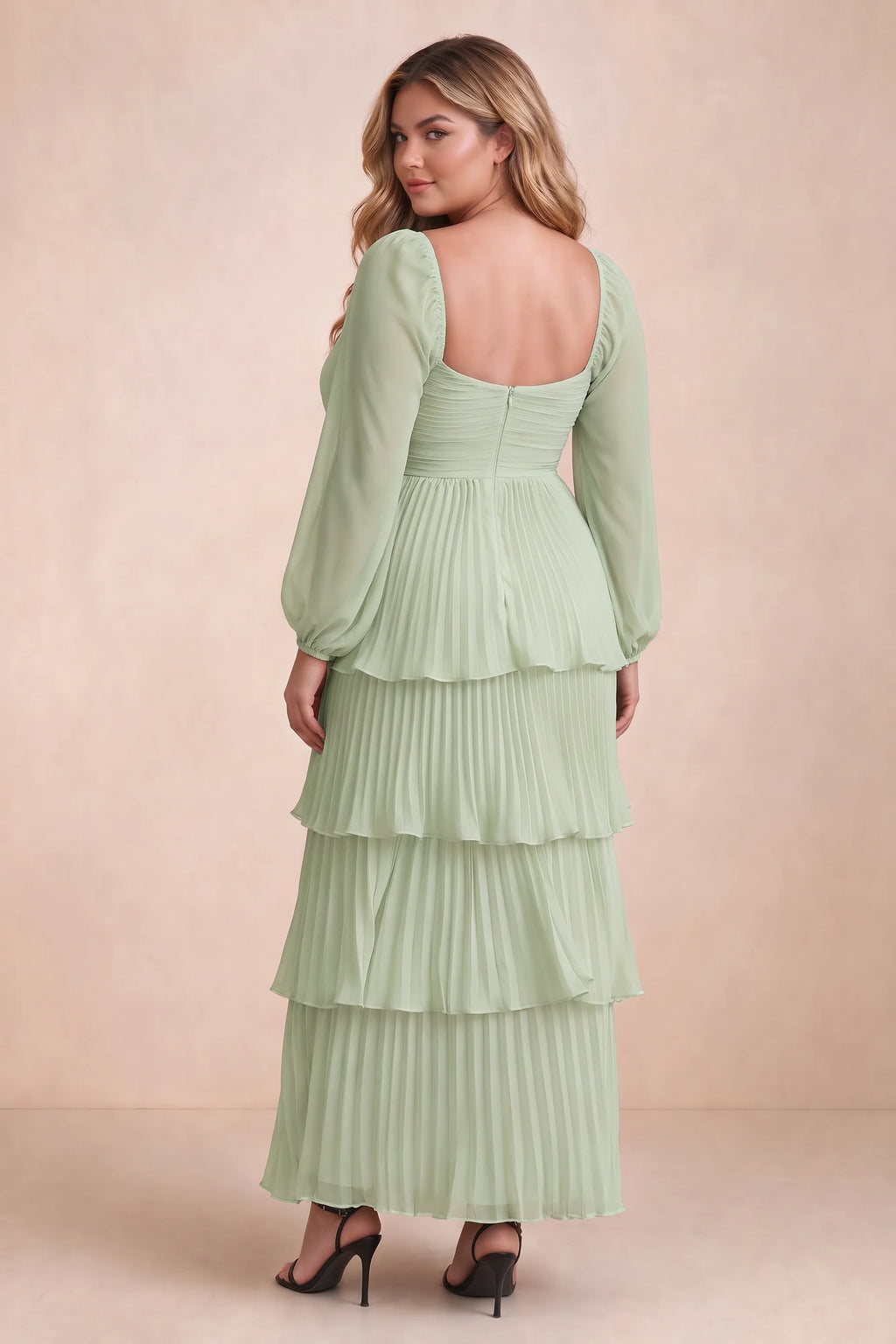 Rear view on a second model of Sienna light green tiered pleated maxi dress with a long flowing skirt