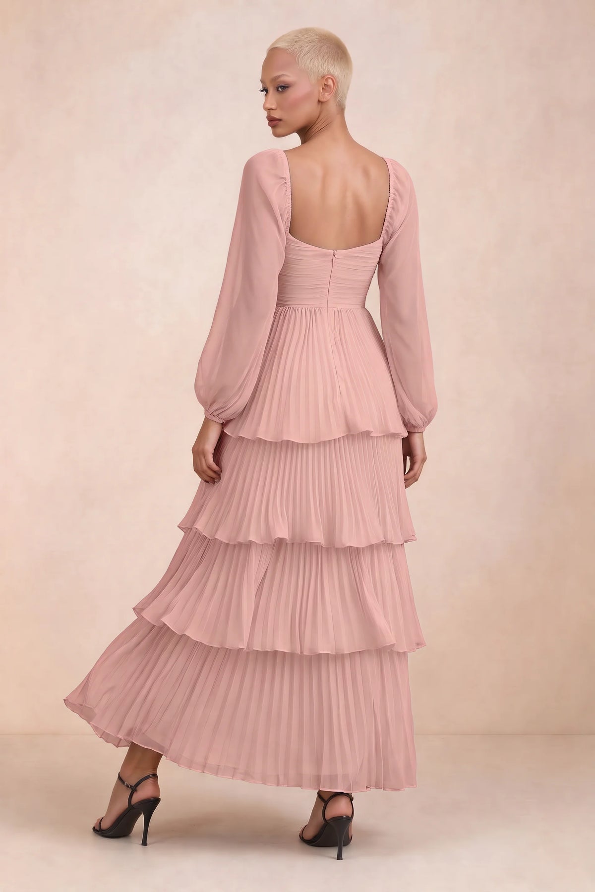 Rear studio view of Sienna light pink tiered pleated maxi dress with a long flowing skirt