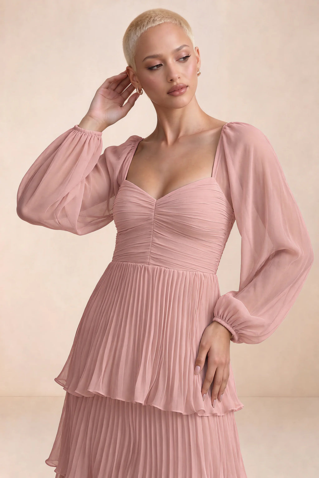Close-up of sweetheart neckline, sheer sleeves and ruched waist of Sienna light pink tiered pleated maxi dress