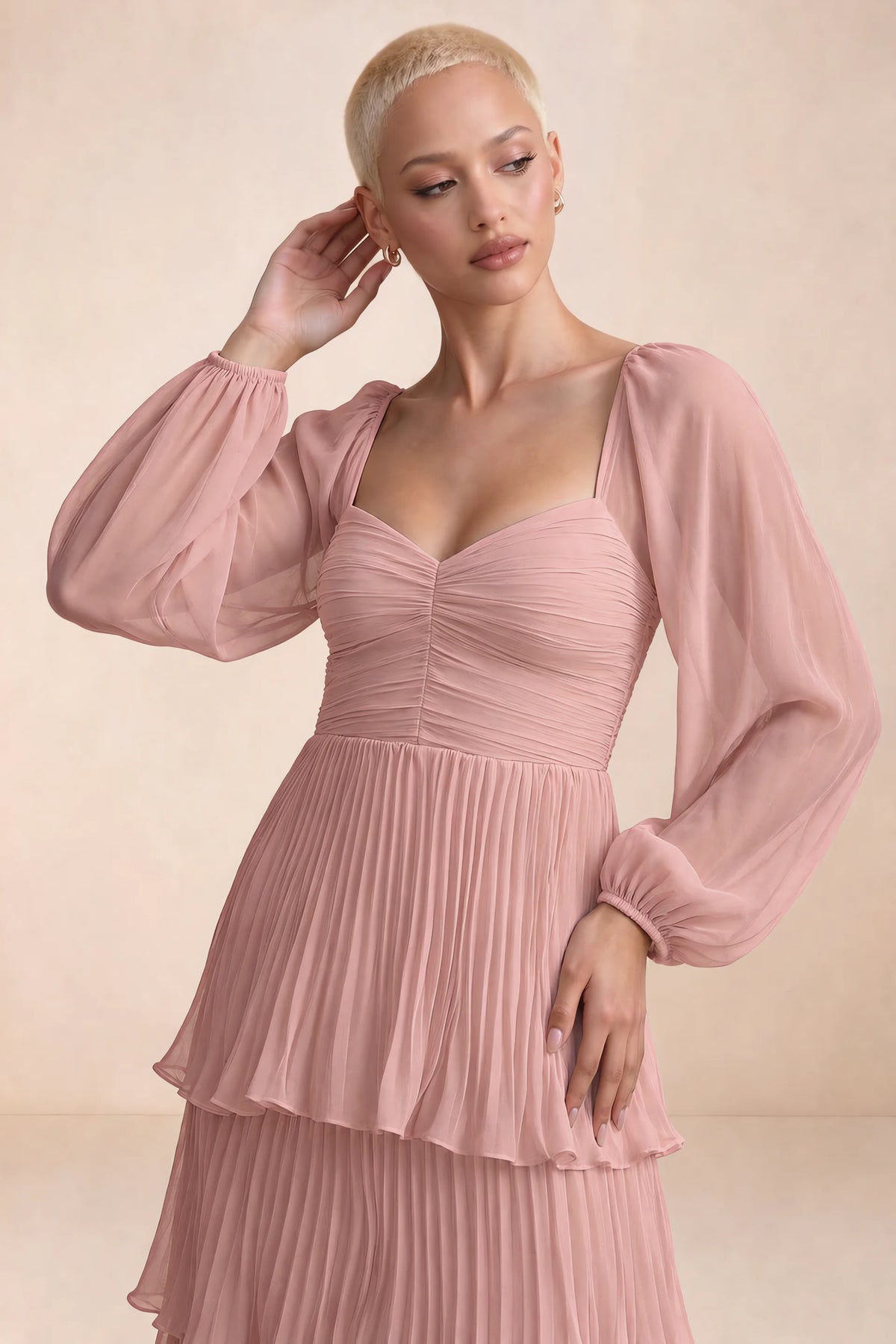 Close-up of sweetheart neckline, sheer sleeves and ruched waist of Sienna light pink tiered pleated maxi dress