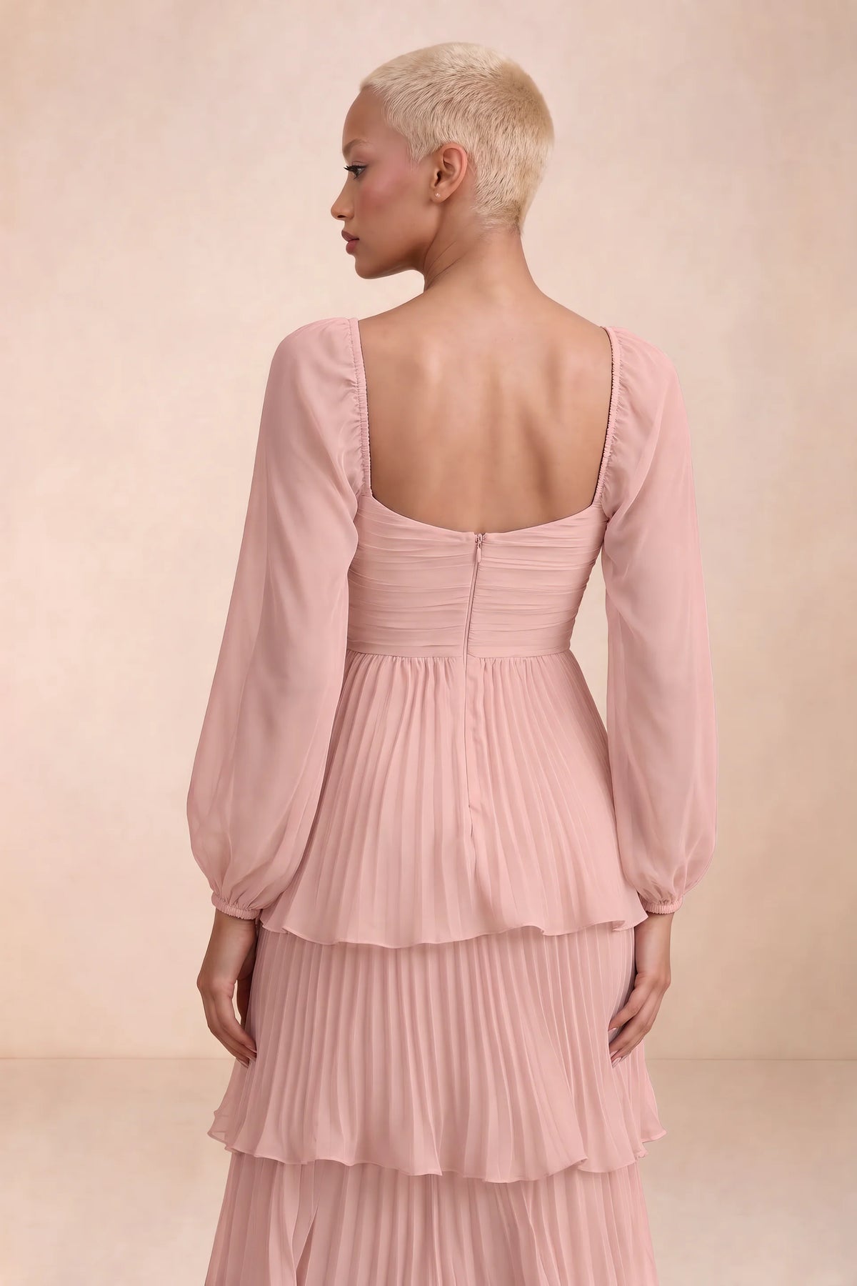 Close-up of low square back, sheer sleeves and centre-back zipper of Sienna light pink tiered pleated maxi dress