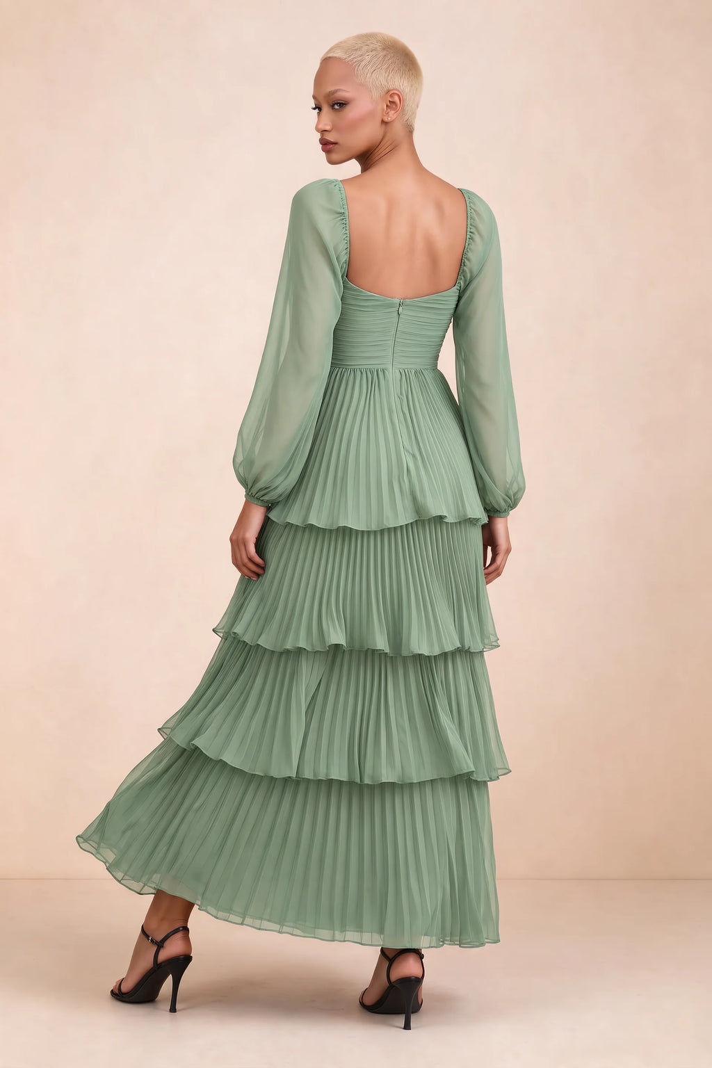Rear studio view of Sienna matcha green tiered pleated maxi dress with a long flowing skirt