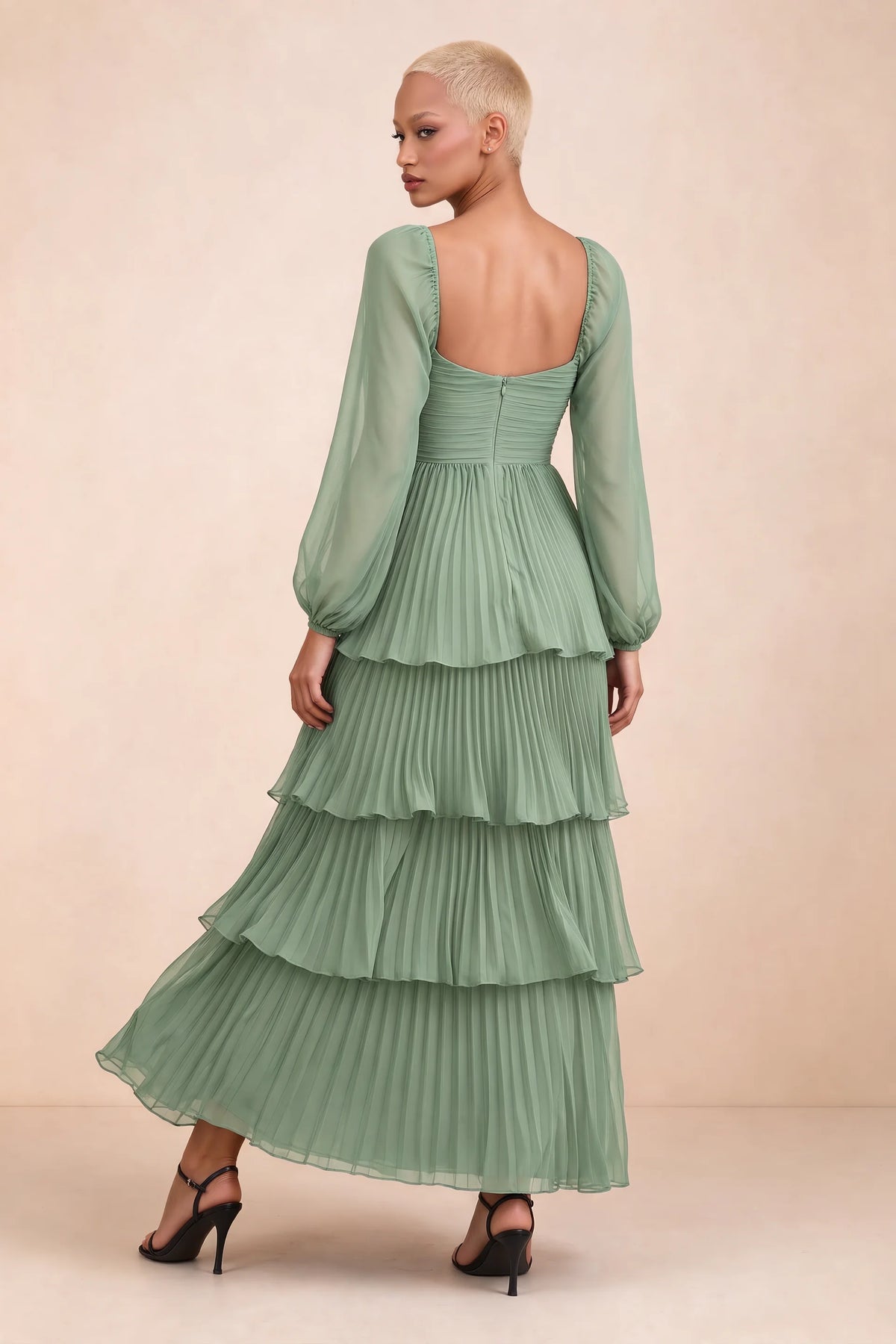 Rear studio view of Sienna matcha green tiered pleated maxi dress with a long flowing skirt