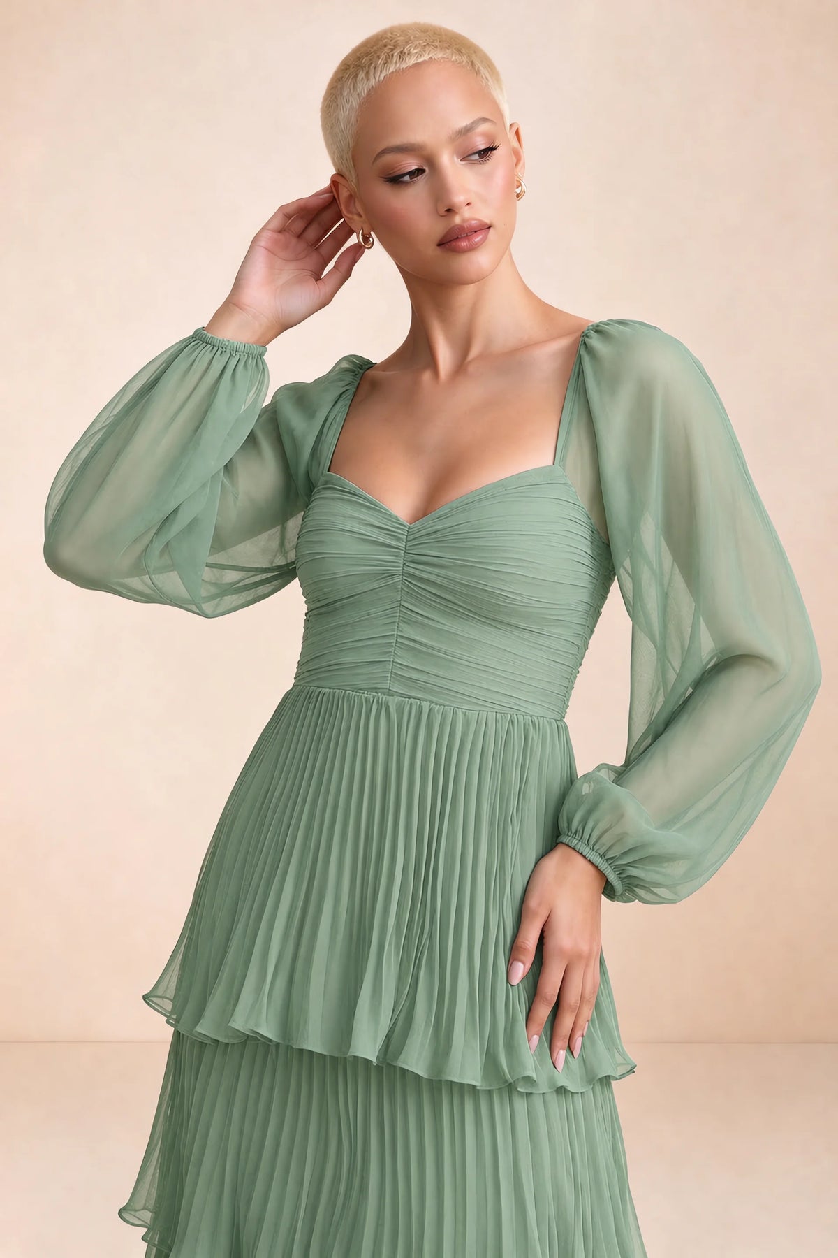 Close-up of sweetheart neckline, sheer sleeves and ruched waist of Sienna matcha green tiered pleated maxi dress