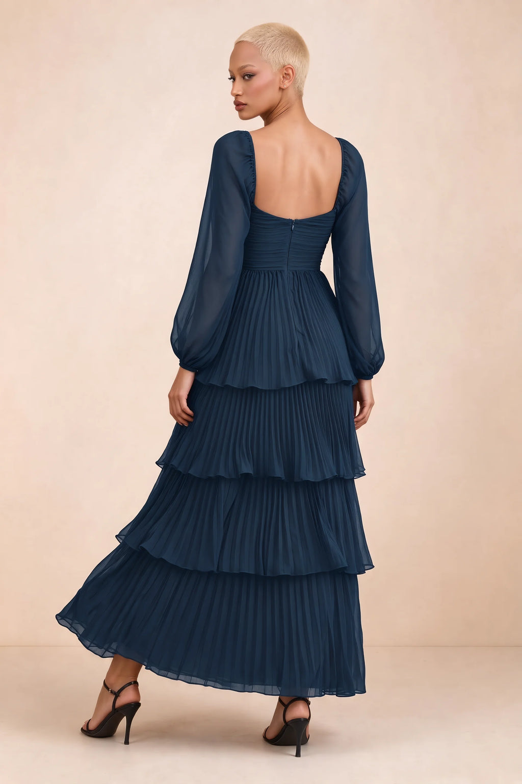 Rear studio view of Sienna navy tiered pleated maxi dress with a long flowing skirt