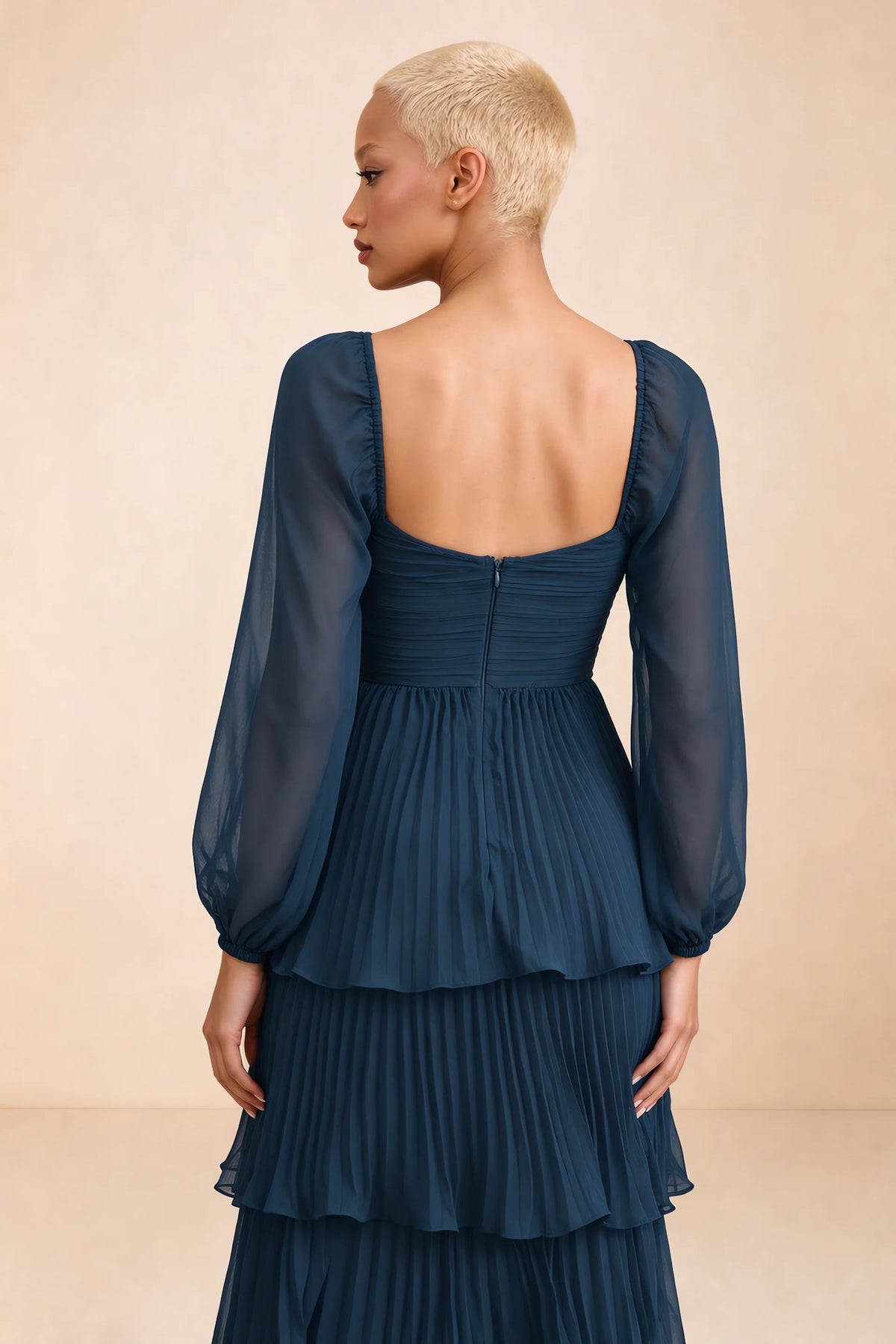 Close-up of low square back, sheer sleeves and centre-back zipper of Sienna navy tiered pleated maxi dress